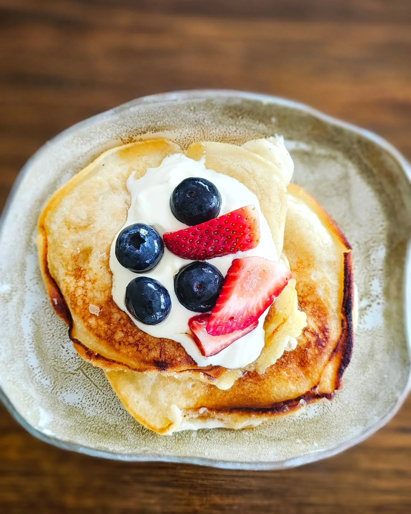Sunday mornings in our kitchen: little hands helping to stir, flour dusting the bench, and pancakes sizzling in the pan. We pile them high with cream and berries, then gather around the table — sticky fingers, giggles, and all. It’s more