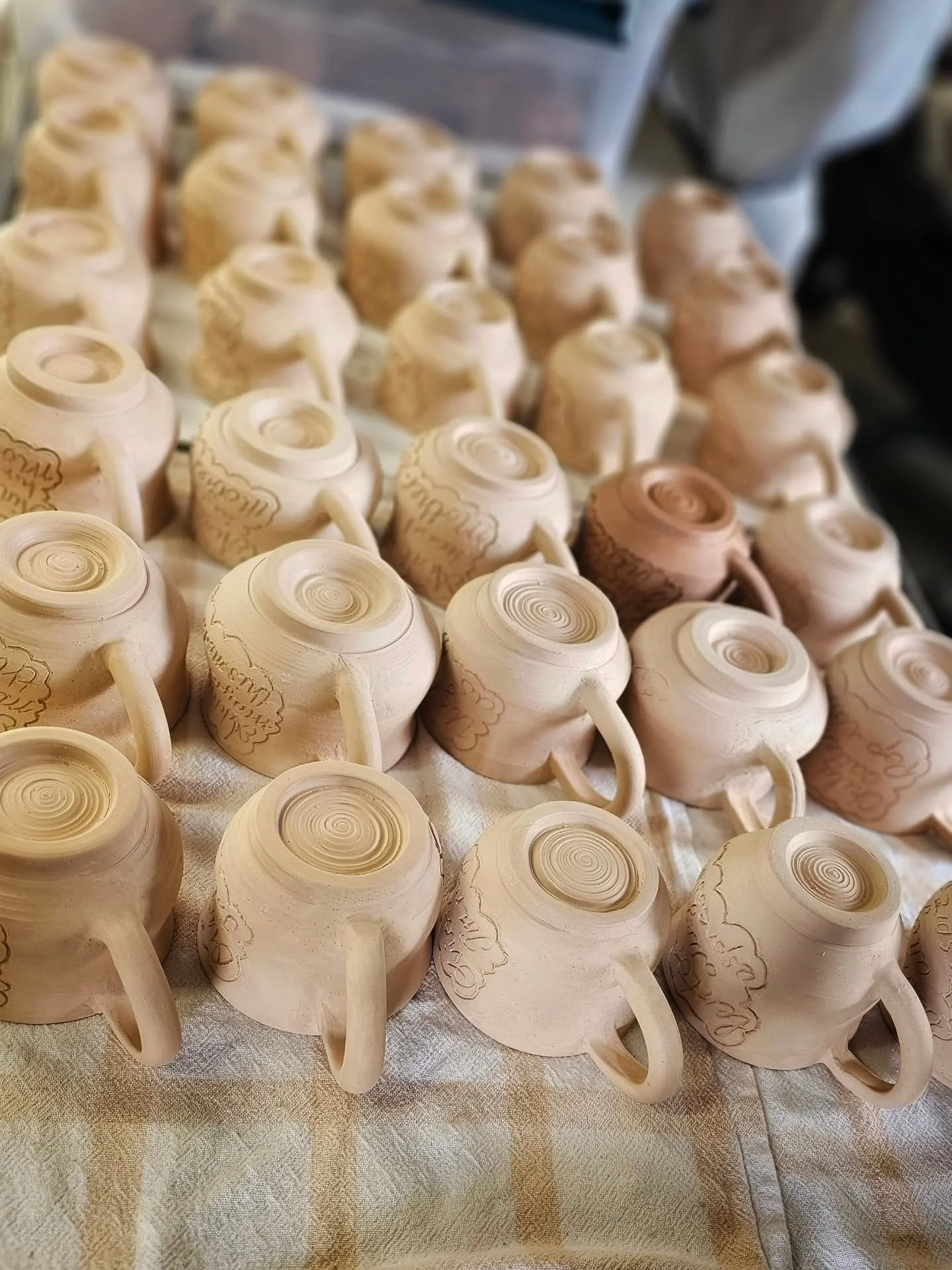 Thirty Smug Mugs &mdash; once drying in neat little rows across the studio, catching the last of the spring light. Now they&rsquo;re fresh from their bisque firing, sitting quietly in the kiln, looking very pleased with themselves (and honestly, fair