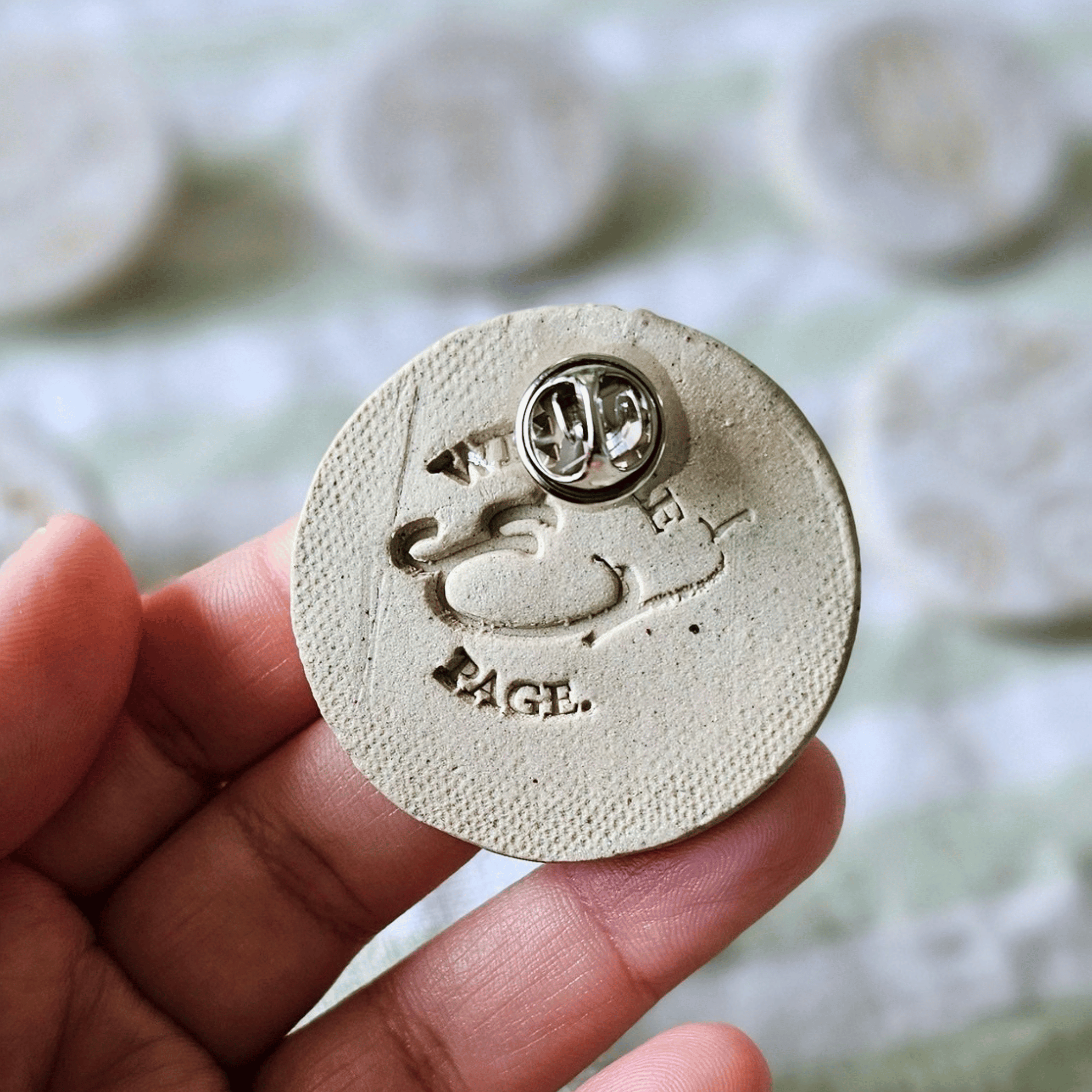 Brooch_sgraffito_white glaze_in hand_back_v2.png