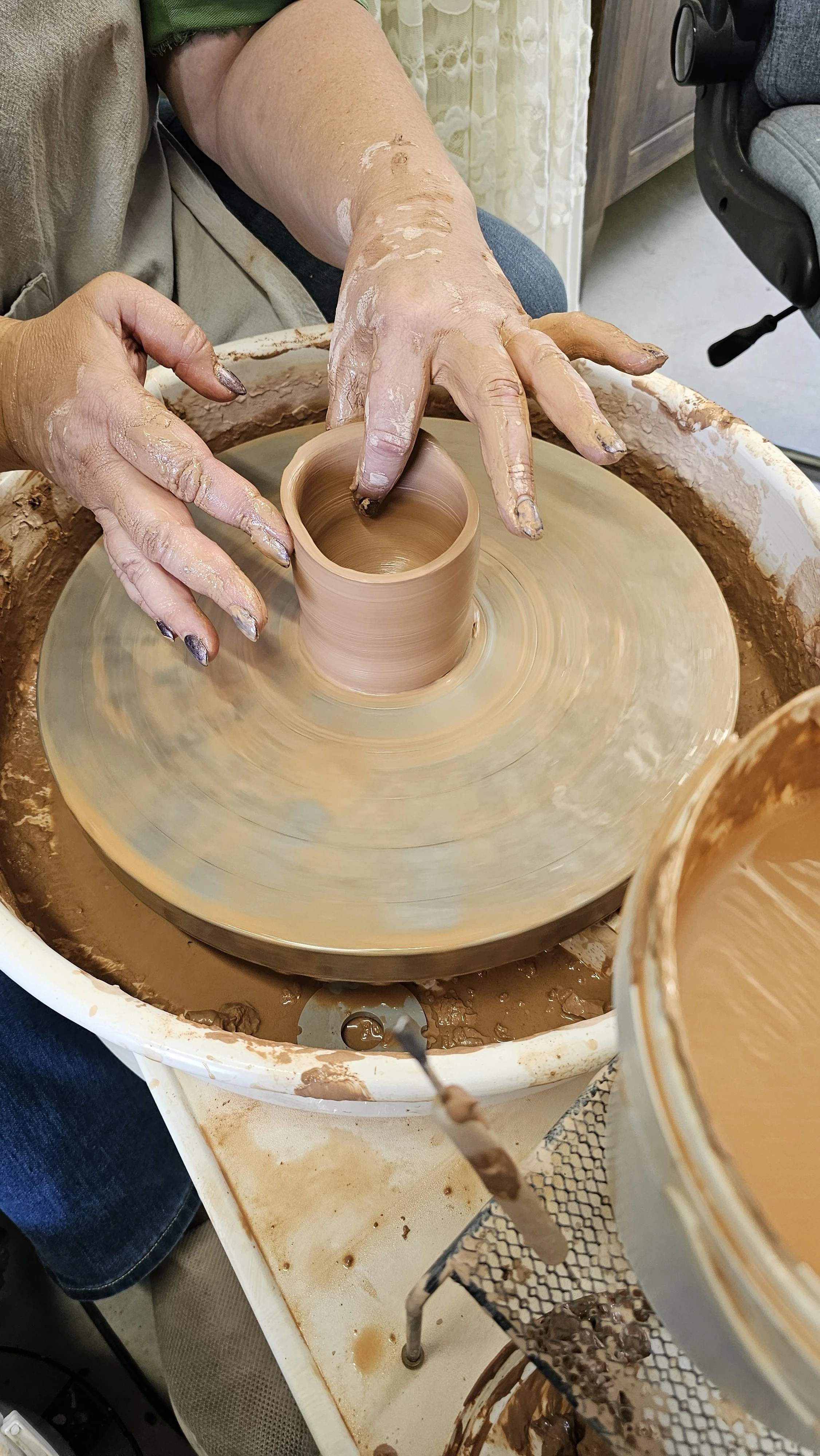 Clay rising and shifting as it’s shaped into form during a guided session