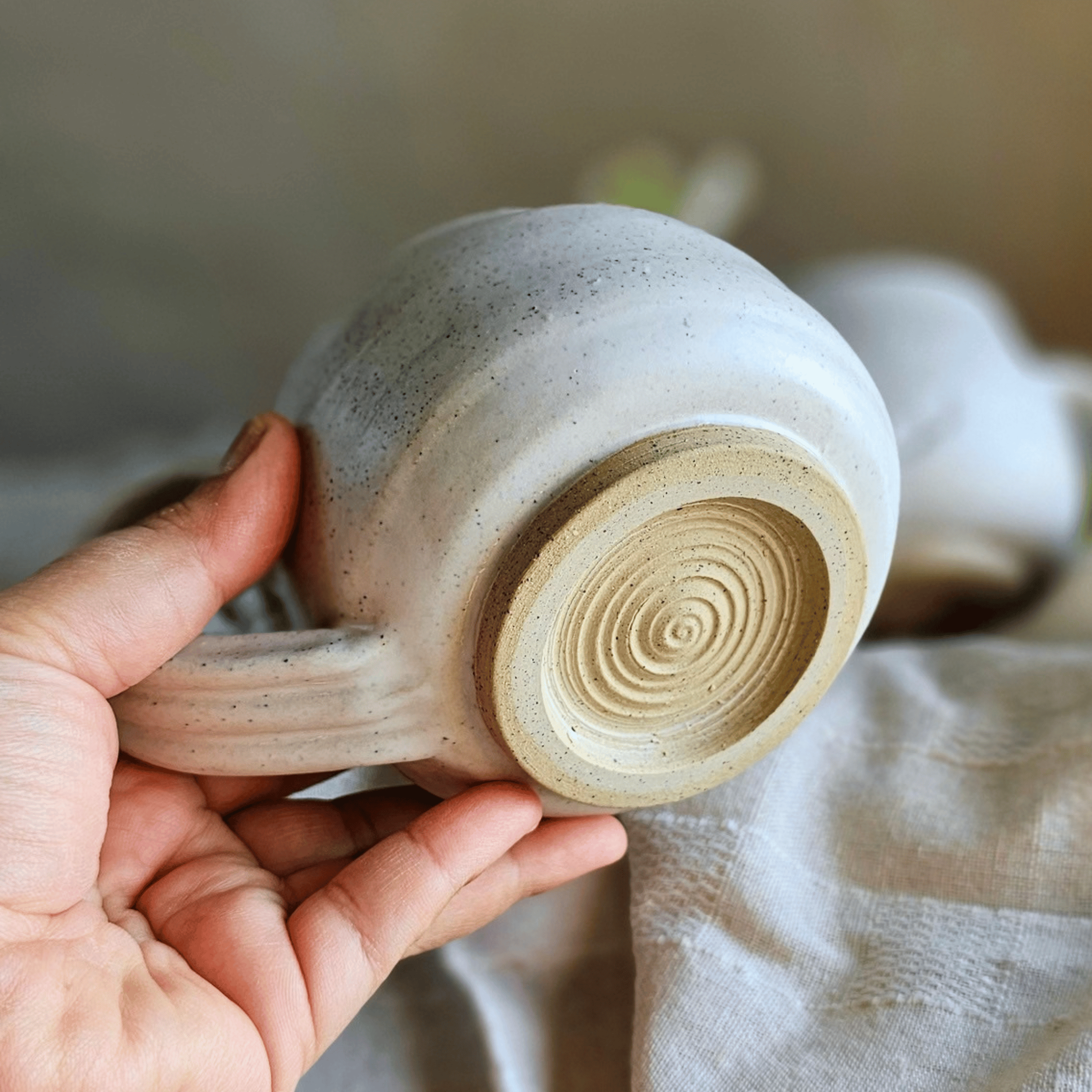 Cuddle Cups_White_Handled_base_in hand.png