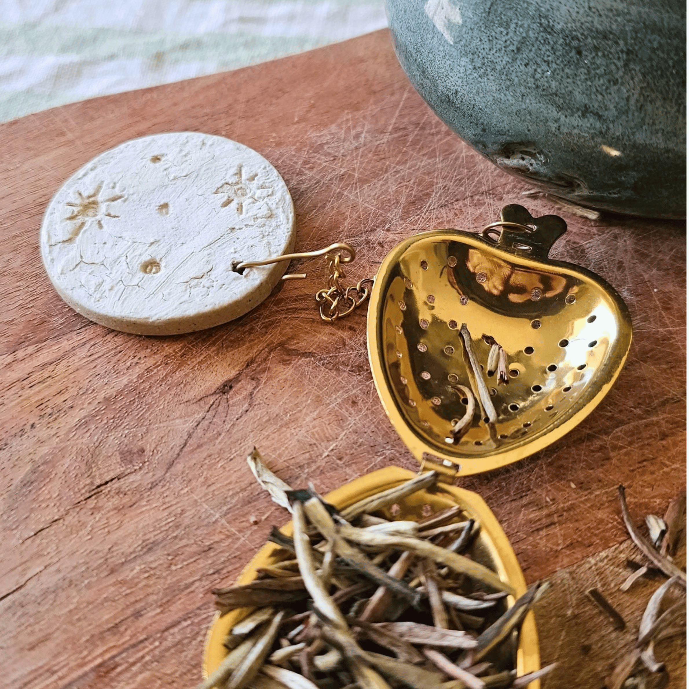 Brew Buddies_sgraffito_white glaze_moon with craters_close up.png