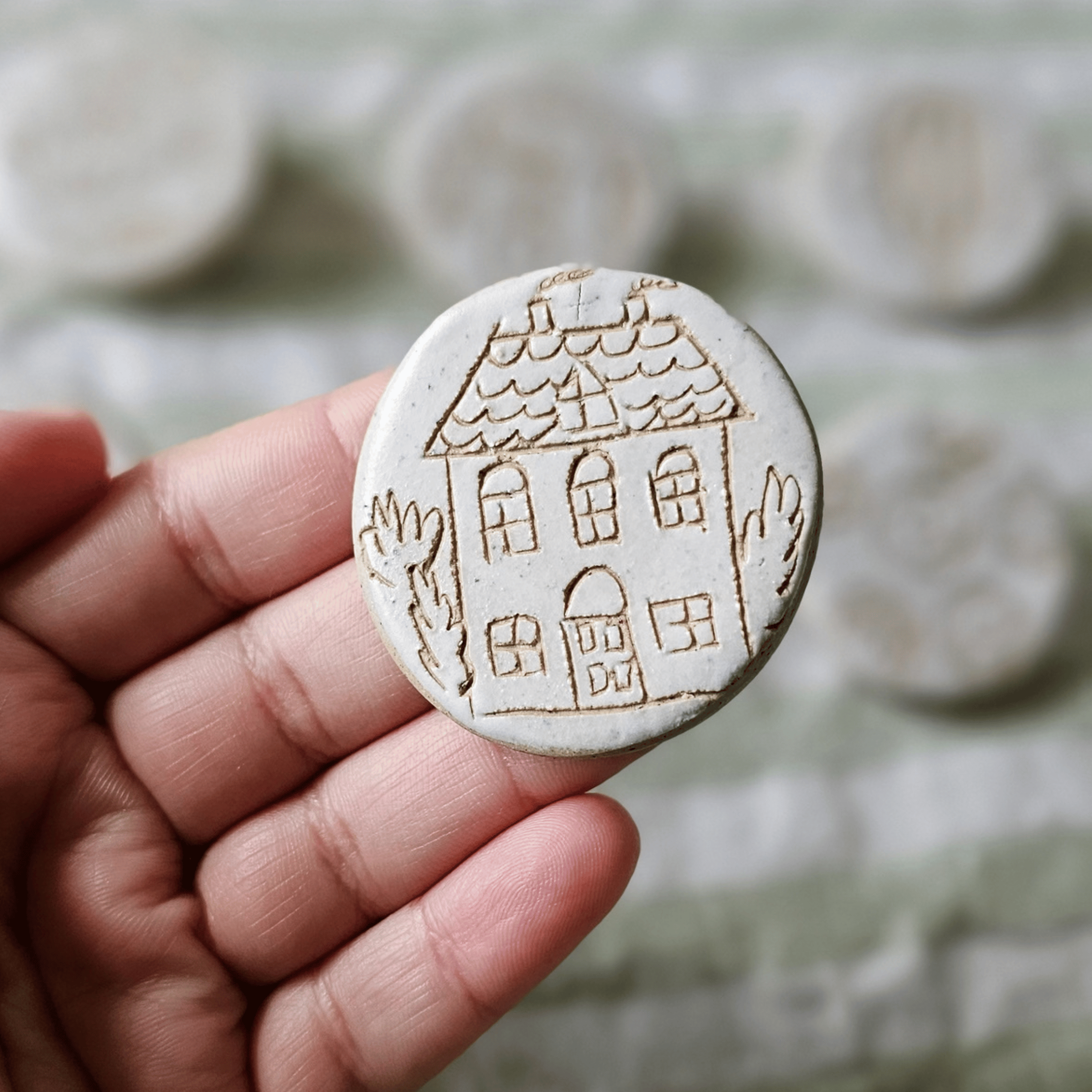 Brooch_sgraffito_white glaze_in hand_townhouse.png