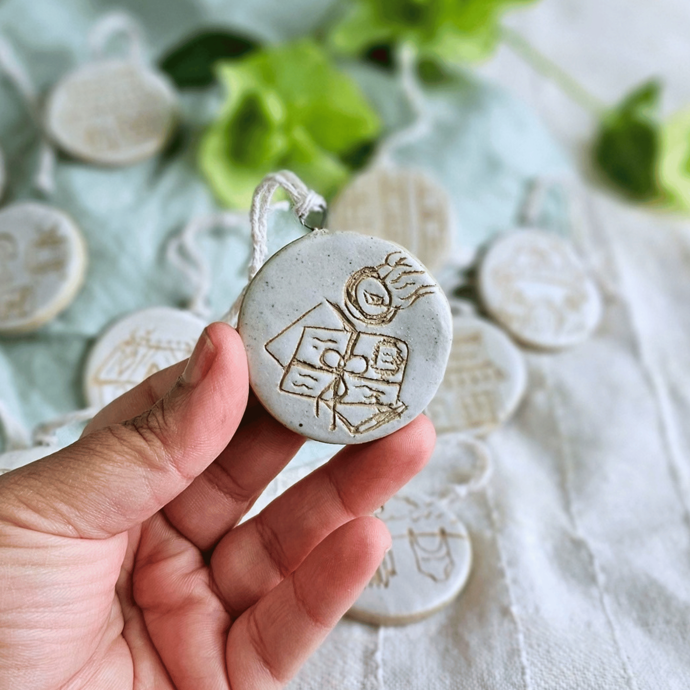 Ornaments_sgraffito_white glaze_in hand_letters and postmark.png