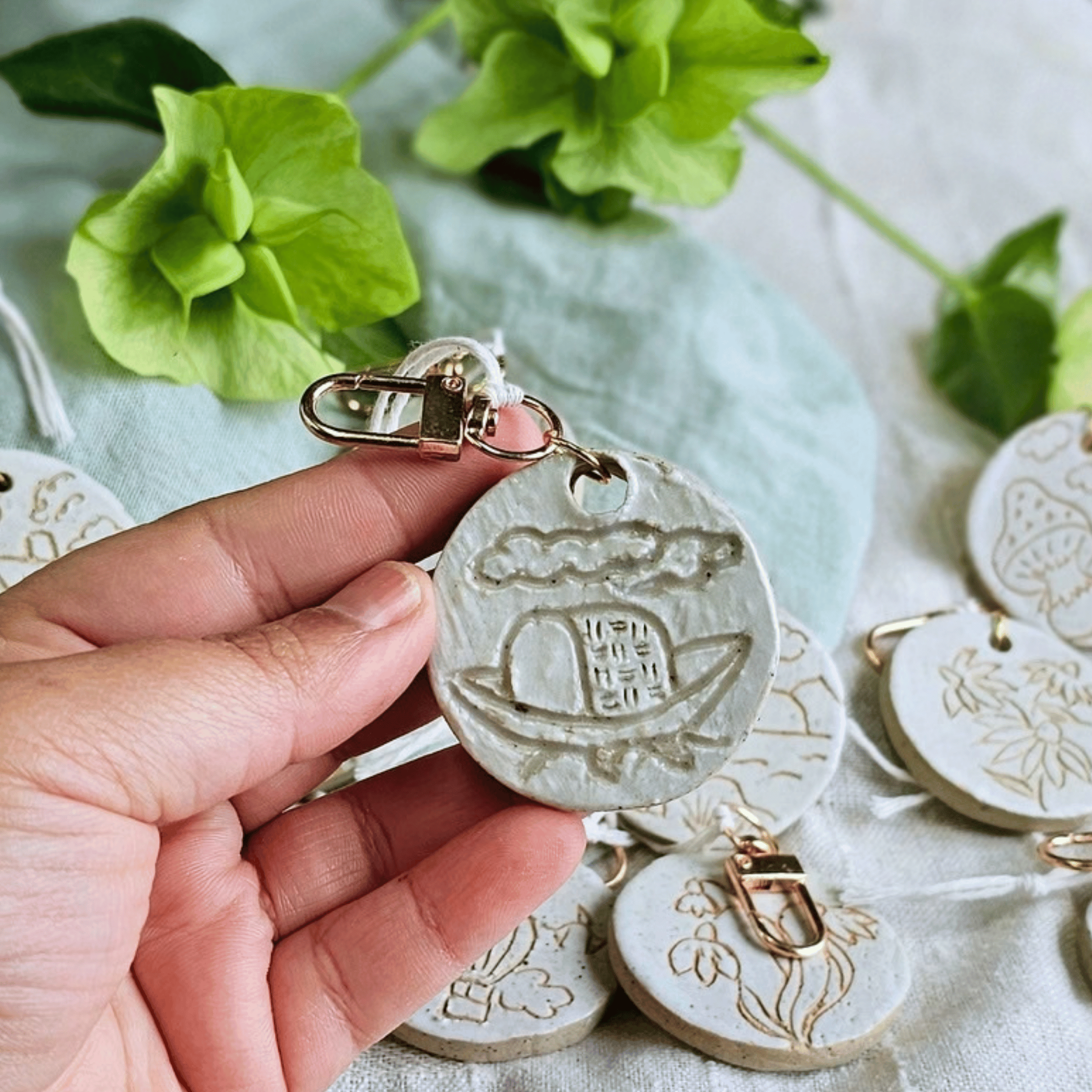 Bag Buddies_sgraffito_white glaze_boat, waves, clouds.png