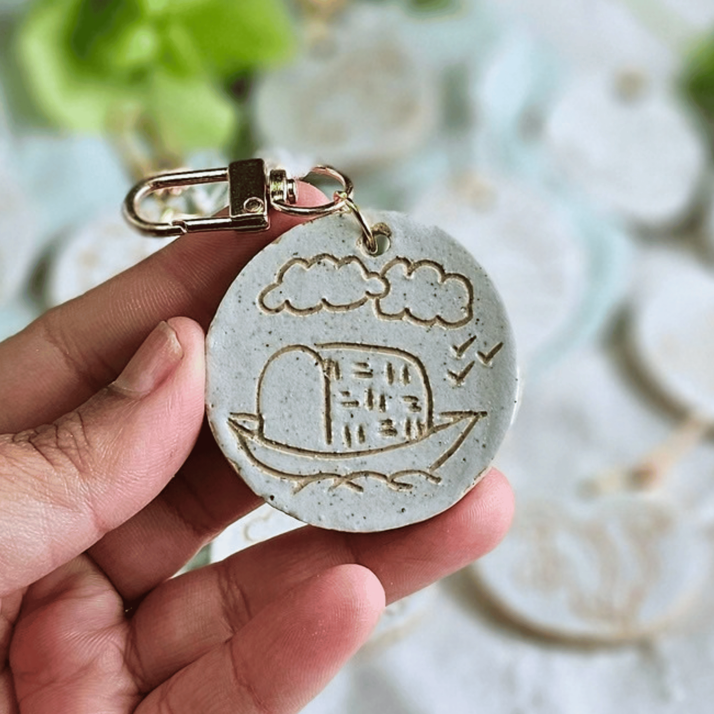 Bag Buddies_sgraffito_white glaze_brown boat with clouds.png