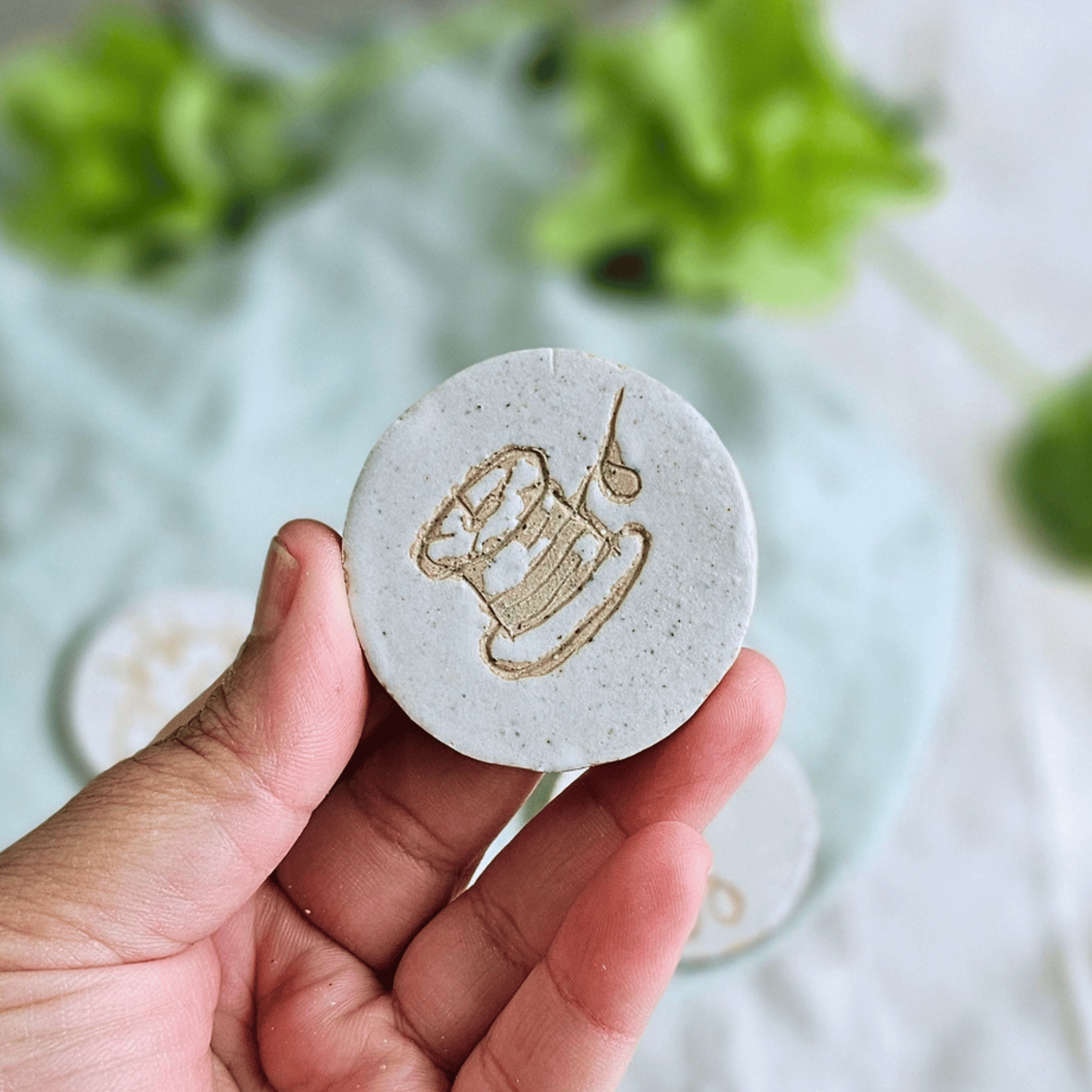 Pattern Weights_sgraffito_white glaze_bobbin.png