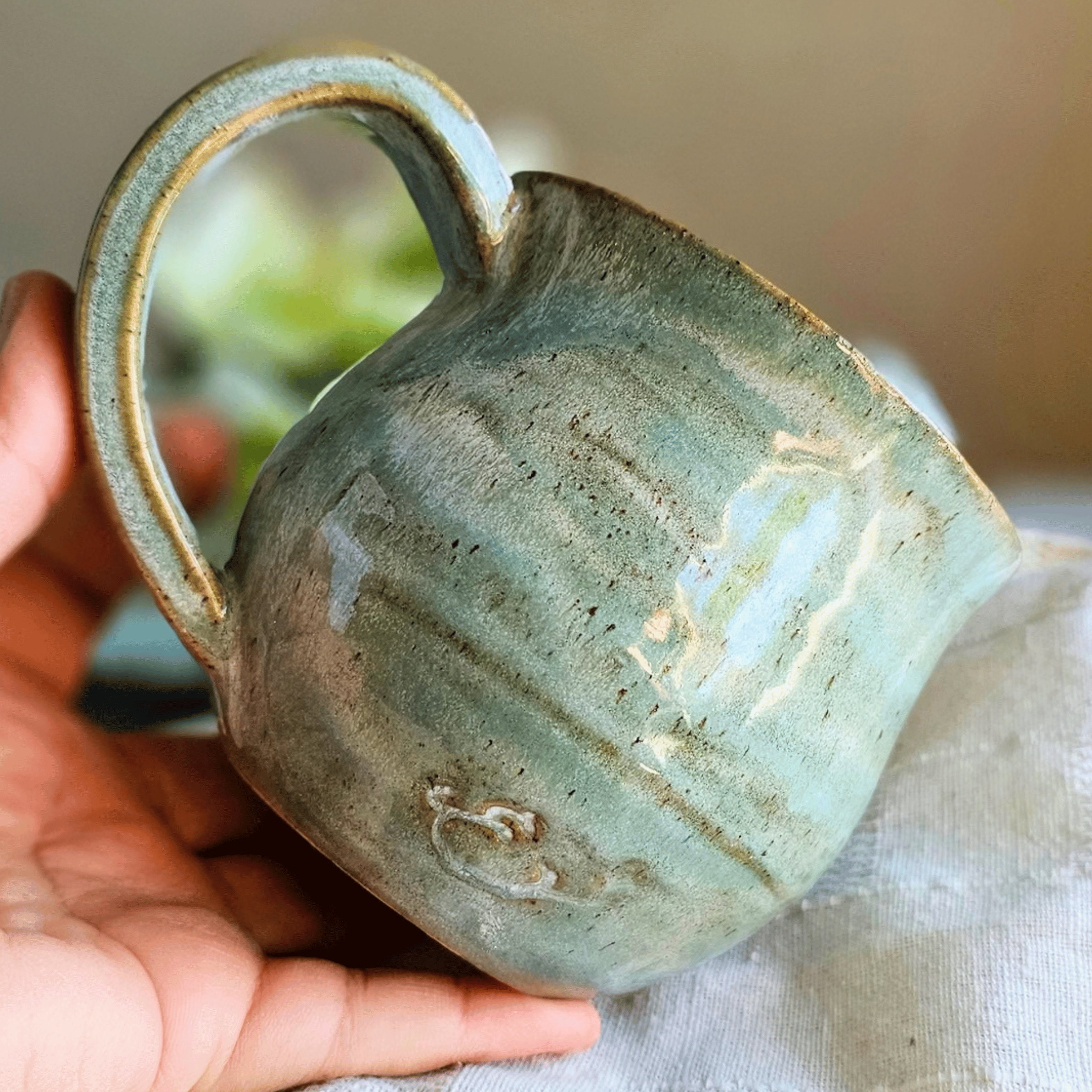 Smug Mug_handled_hand carved_1900s_in hand_back.png
