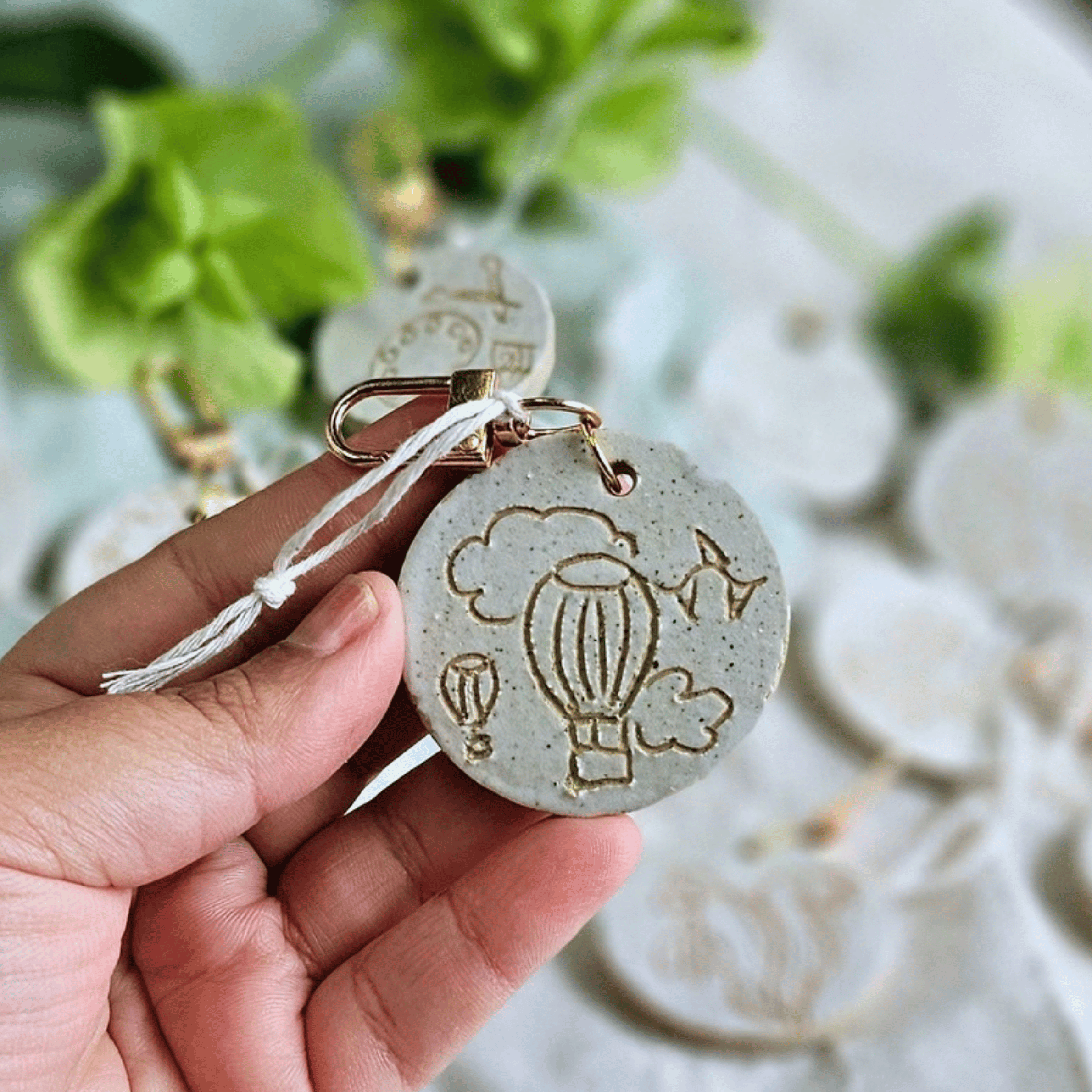Bag Buddies_sgraffito_white glaze_hot air ballons and clouds.png