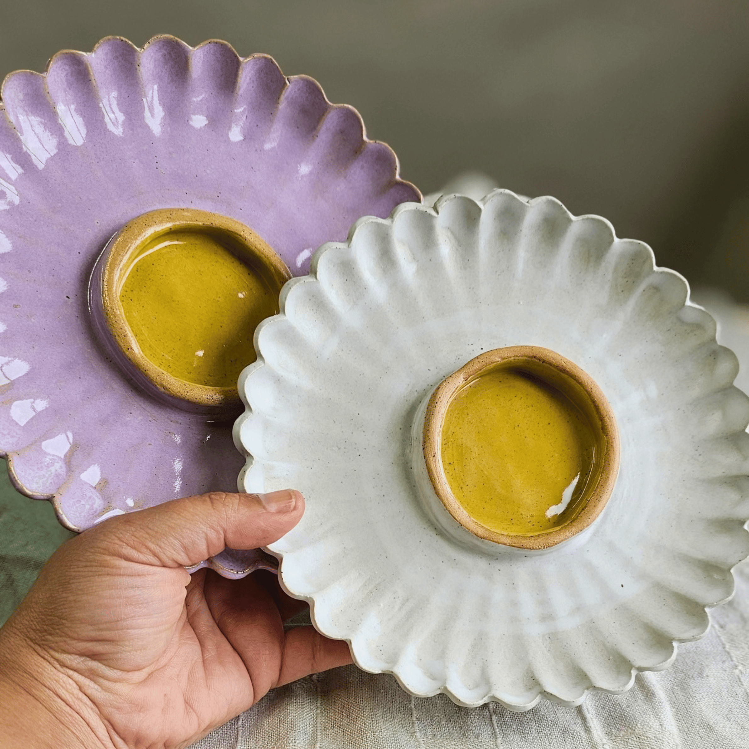 Girl Dinner Plates_Flower shaped_pink and white with yellow_in hand.png
