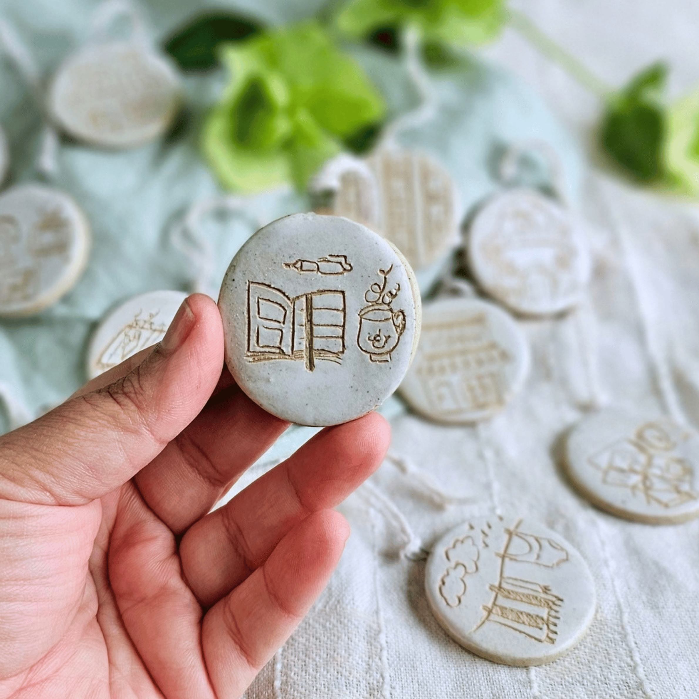Ornaments_sgraffito_white glaze_in hand_open journal pen tea.png