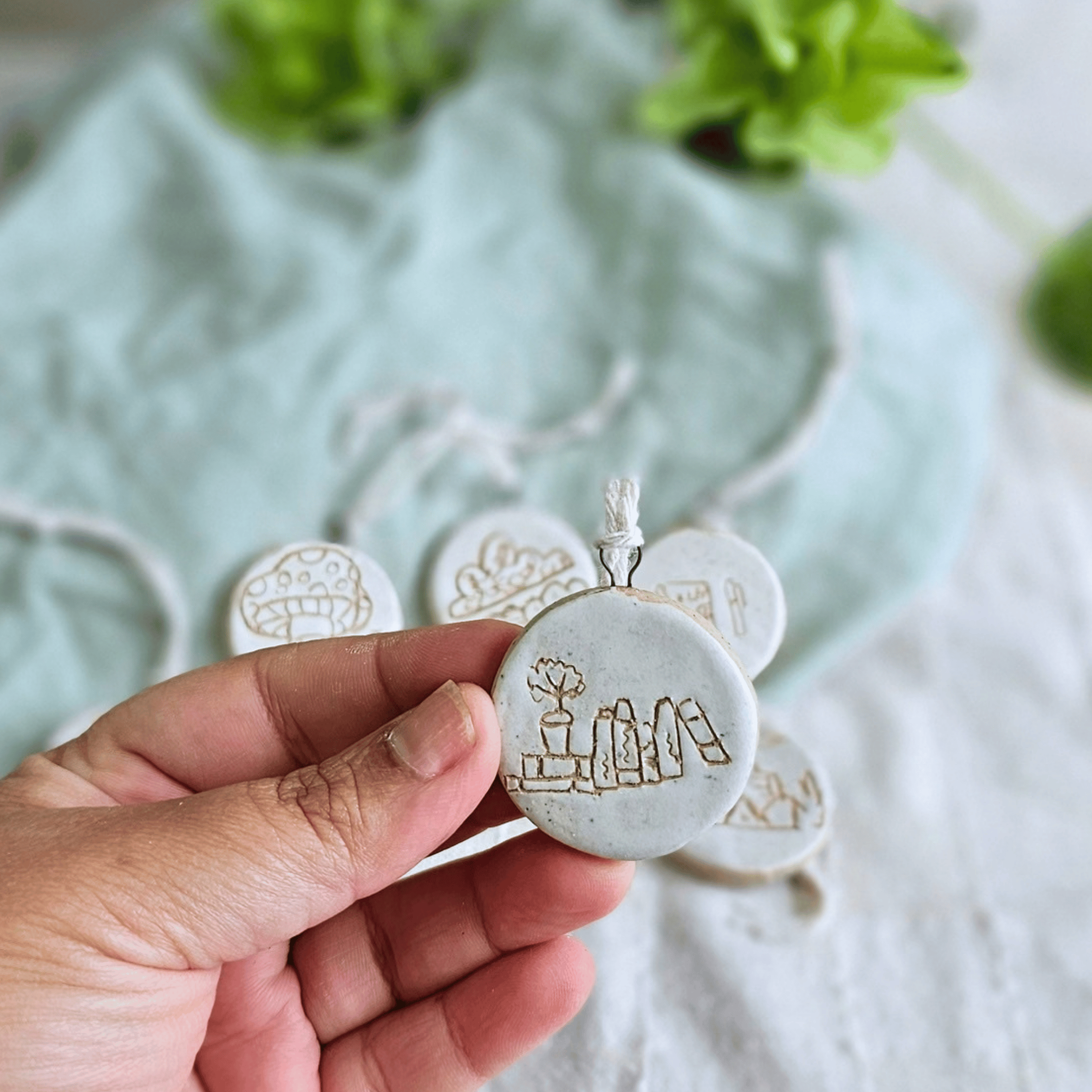 Mini Ornaments_sgraffito_white glaze_books and plant.png