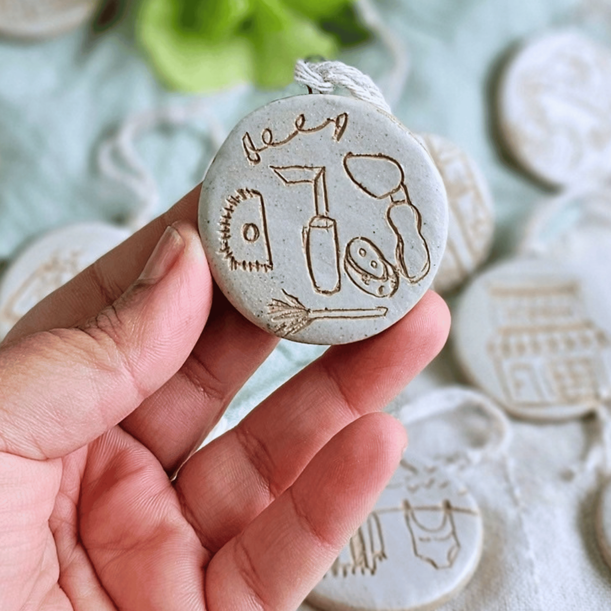 Ornaments_sgraffito_white glaze_in hand_pottery tools.png