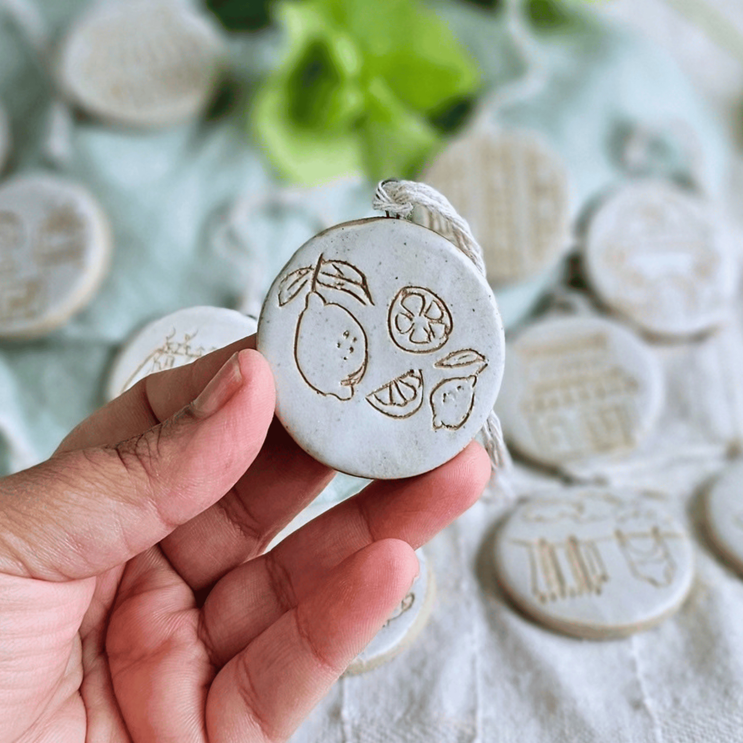 Ornaments_sgraffito_white glaze_in hand_lemons.png