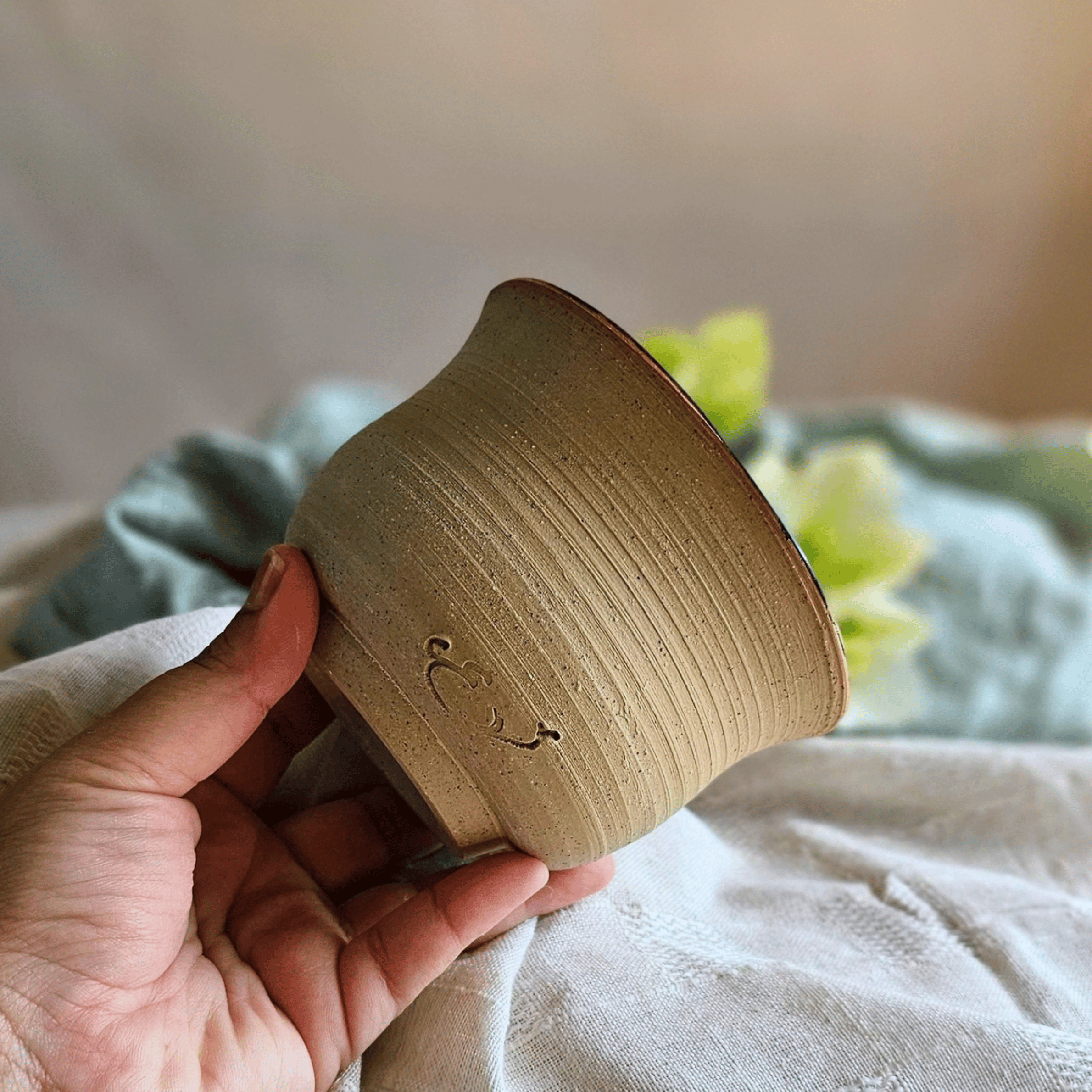 Petrichor Bowl_Raw Clay Exterior_Outside_In hand.png