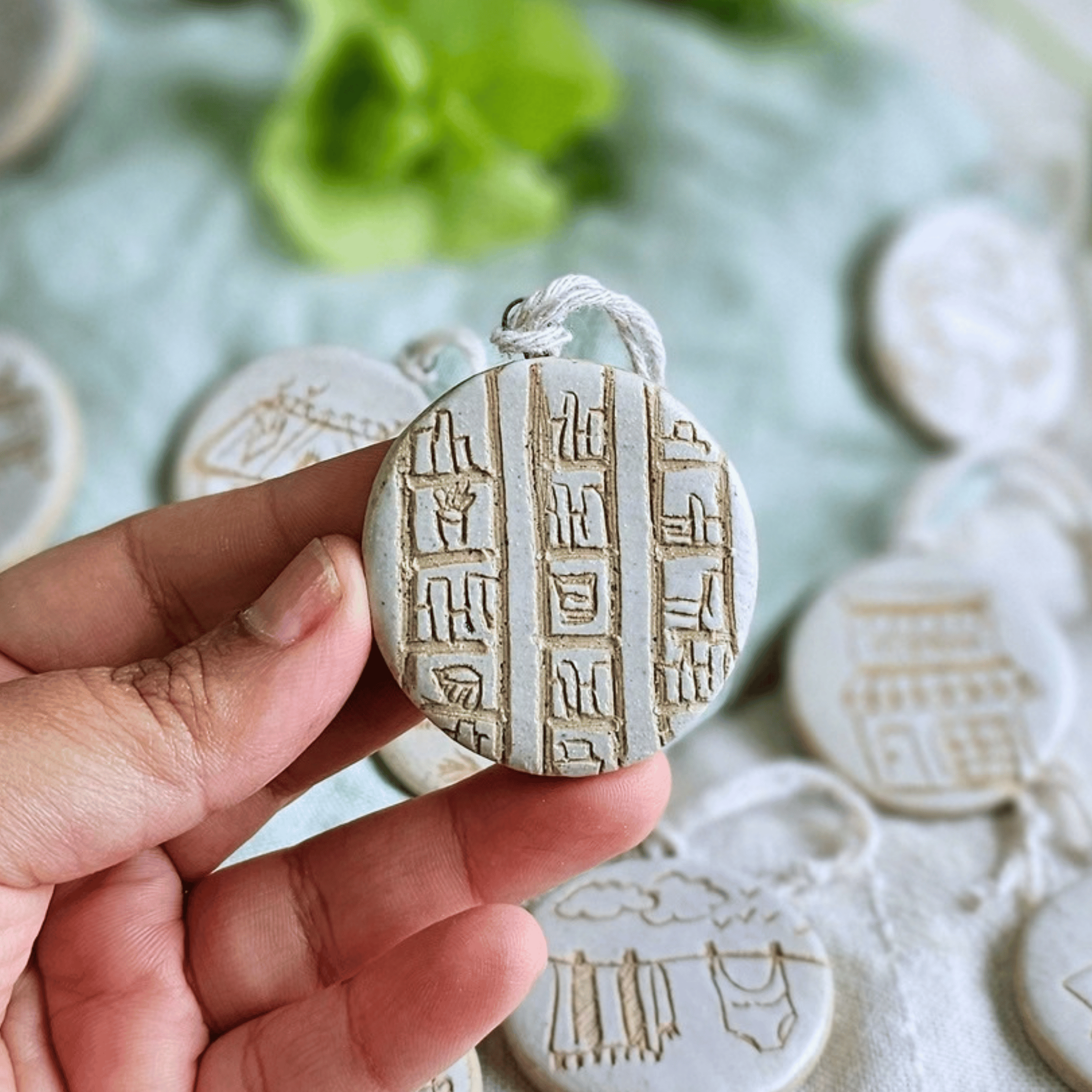 Ornaments_sgraffito_white glaze_in hand_book cases.png