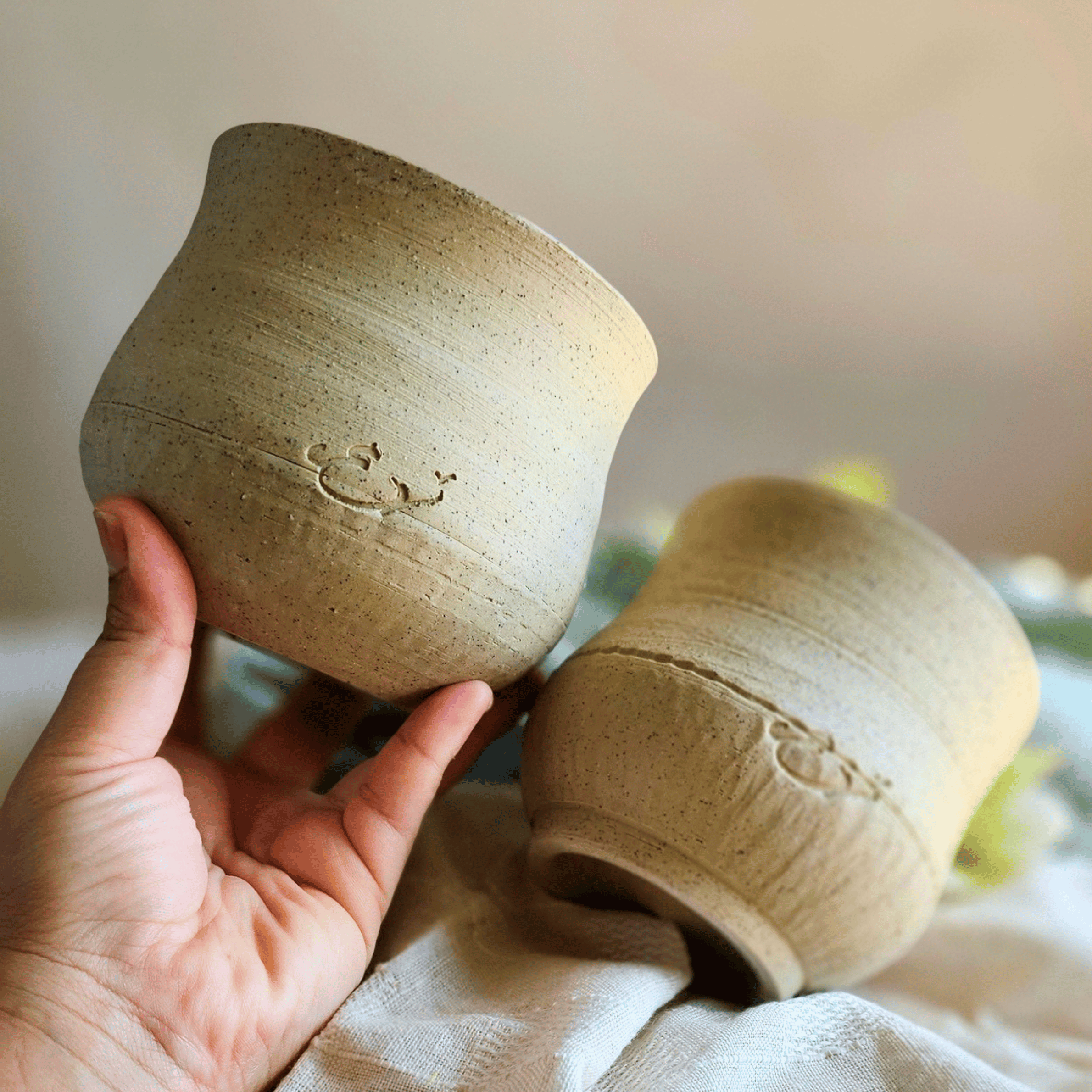 Cosy Cups or Bowls in hand_raw clay_chattered.png