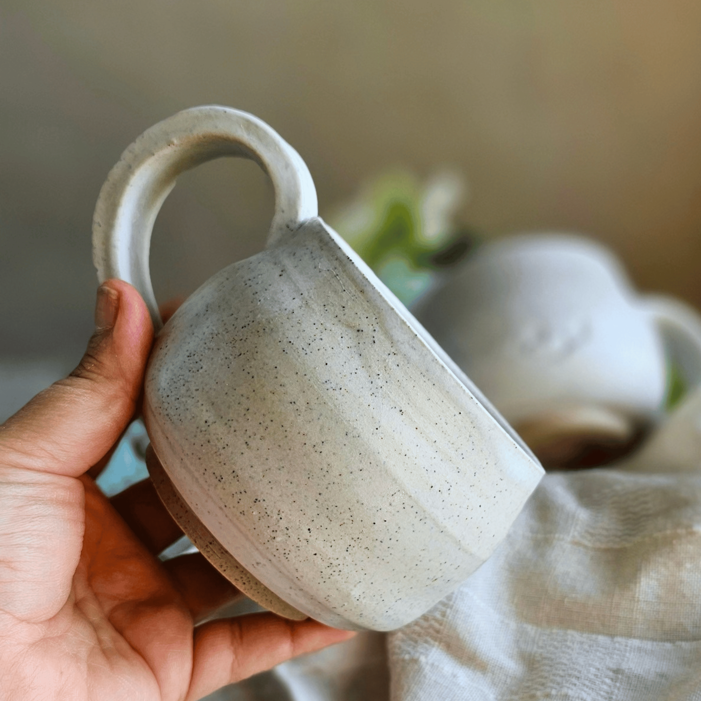 Cuddle Cups_White_Handled_in hand.png