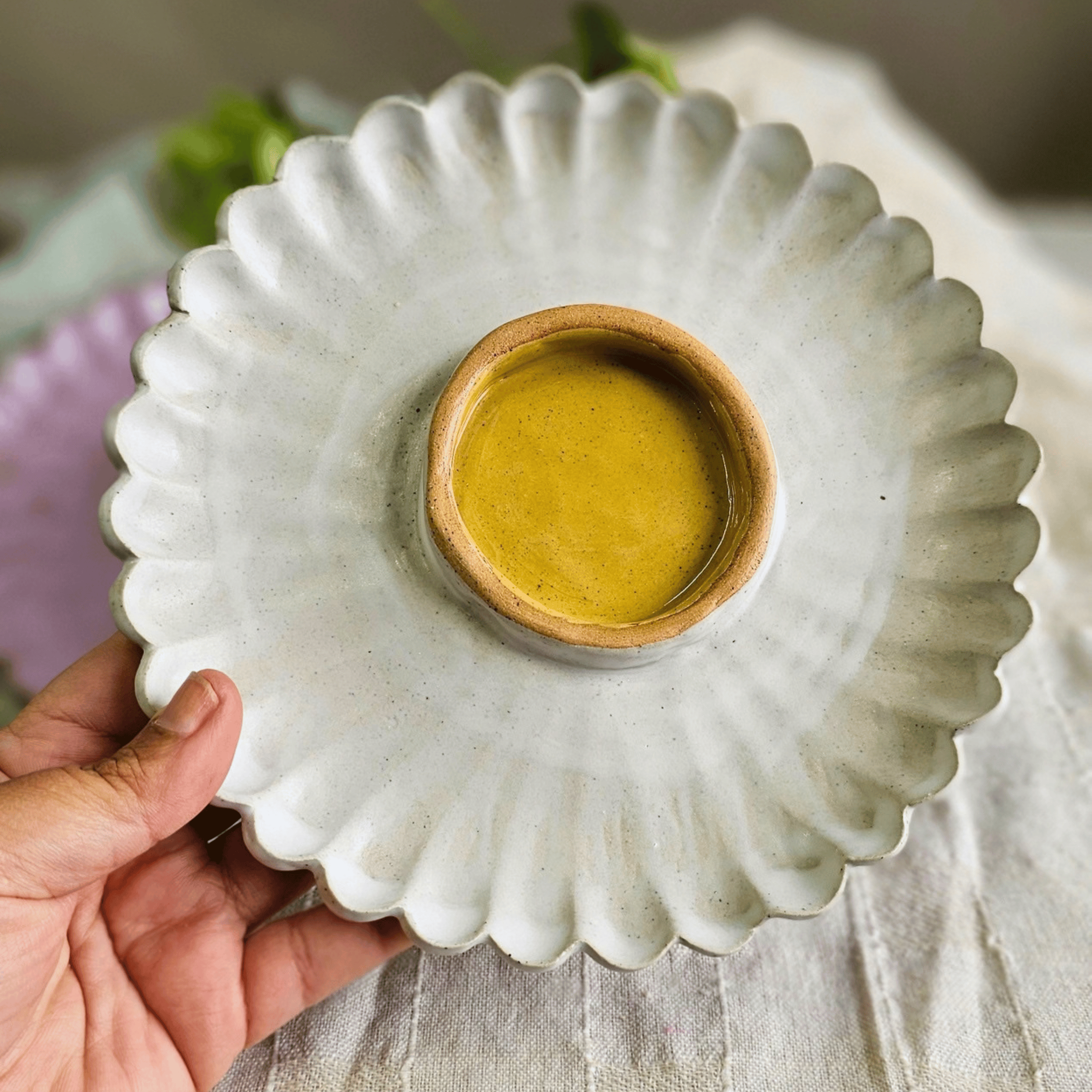 Girl Dinner Plates_Flower shaped_white yellow_in hand_top.png