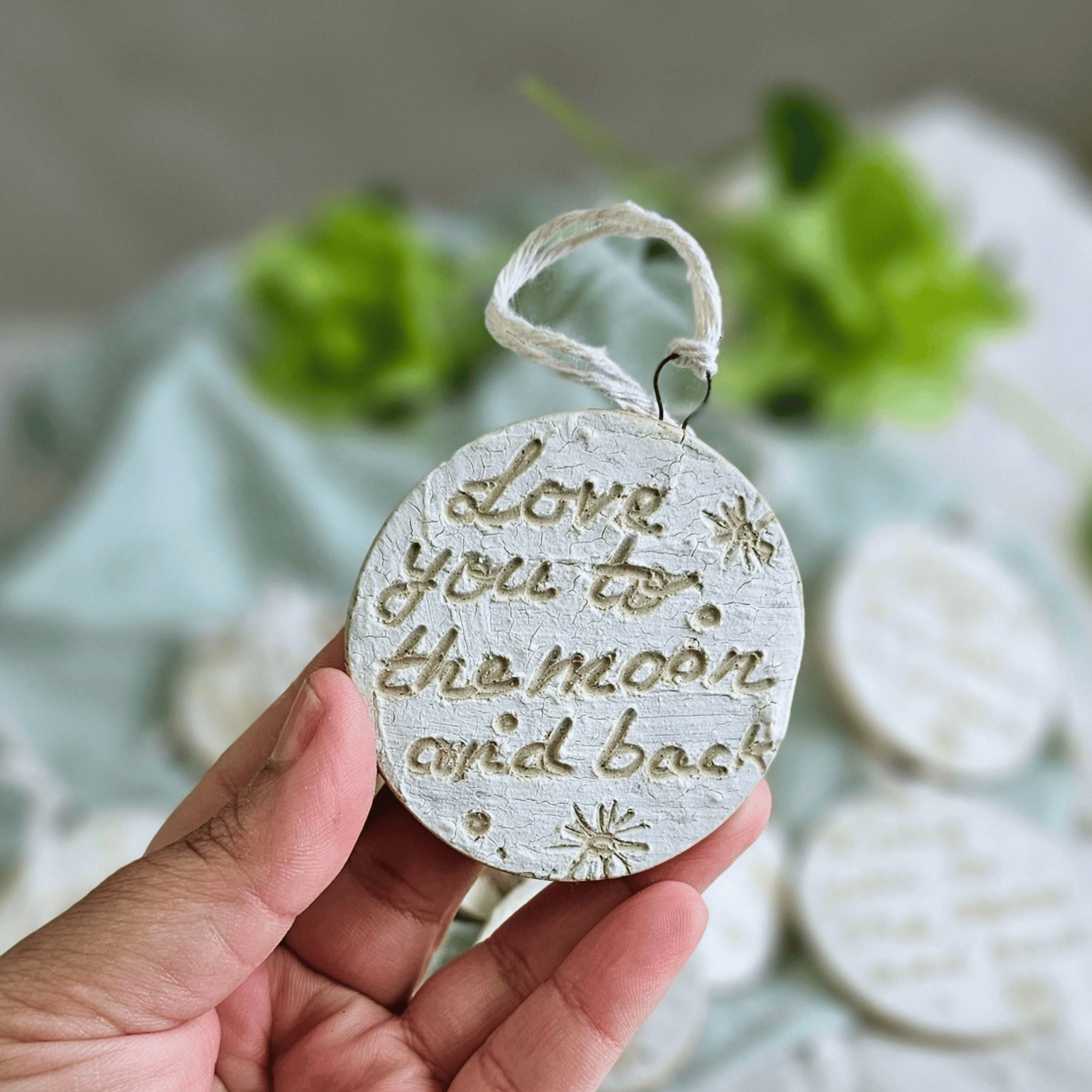 Moon Ornaments_sgraffito_white glaze_in hand_love you.png