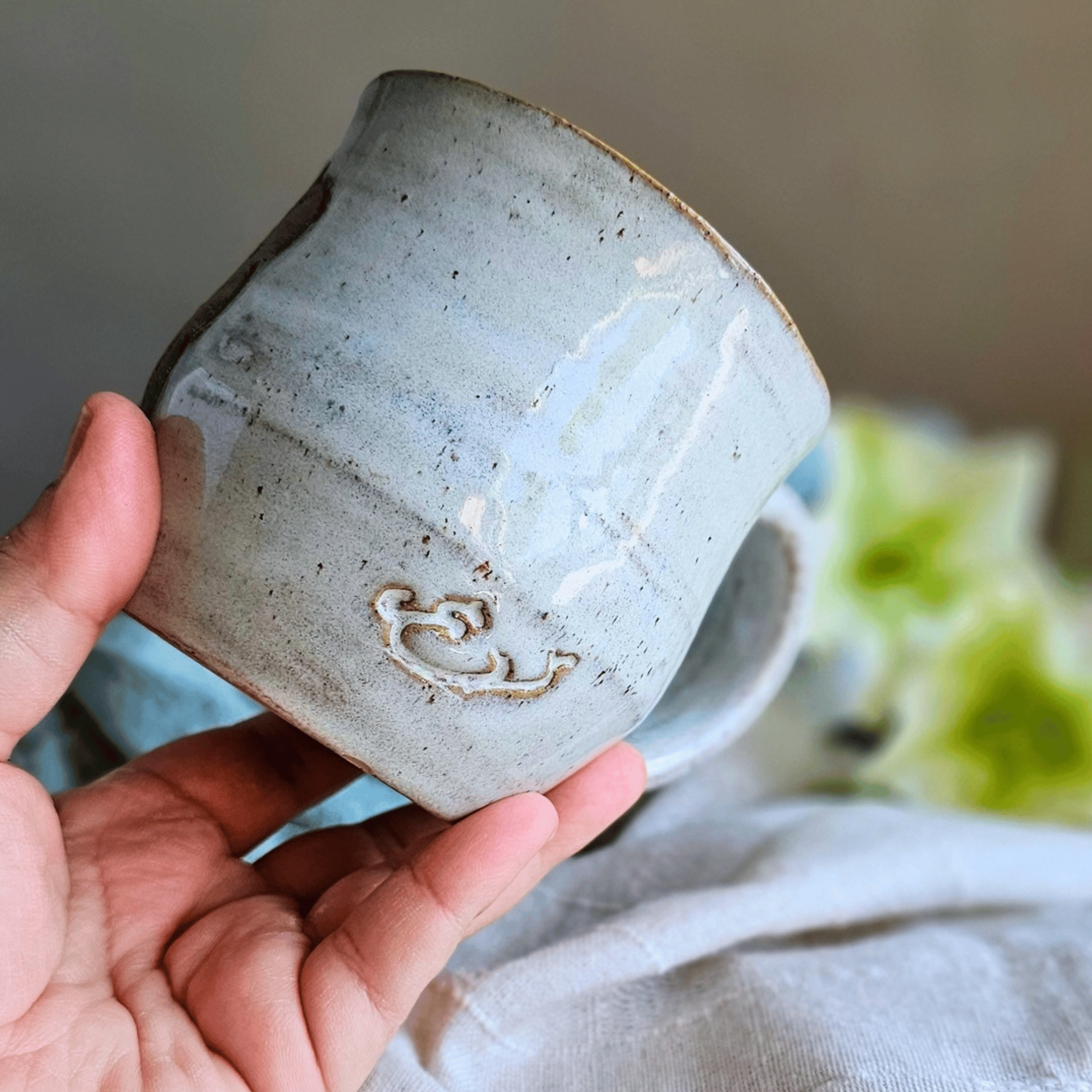 Smug Mug_handled_hand carved_business_back_in hand.png