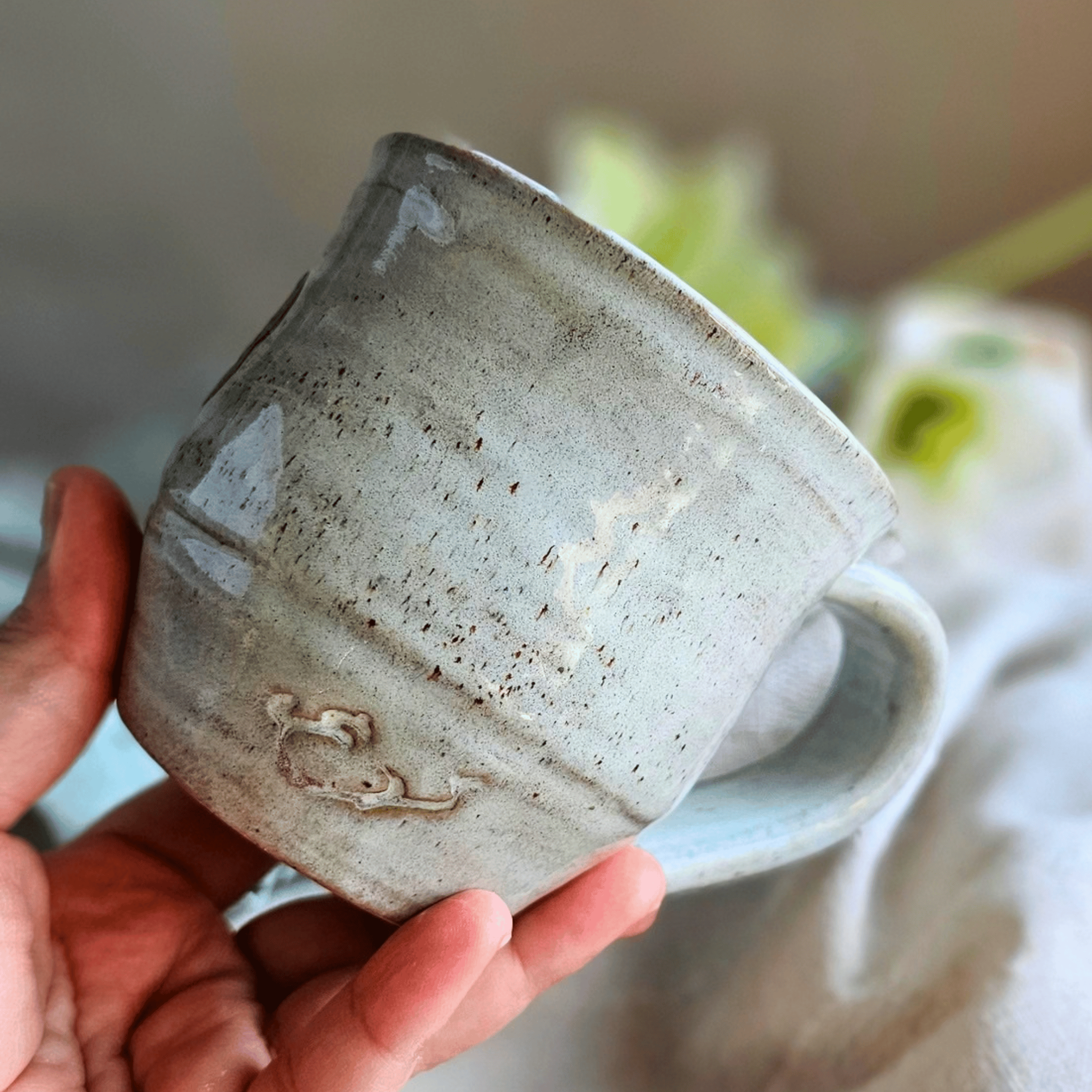 Smug Mug_handled_hand carved_spite_back_in hand.png