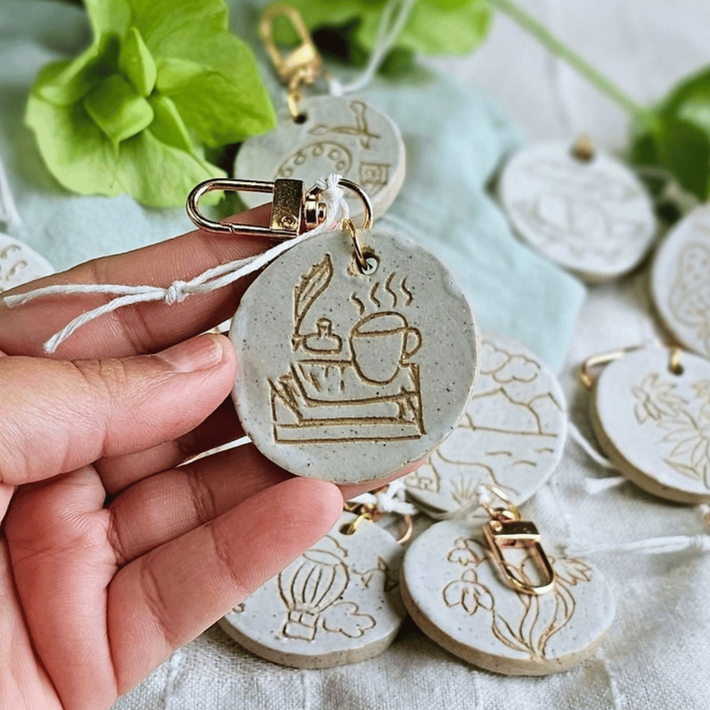 Bag Buddies_sgraffito_white glaze_books tea feather pen.png