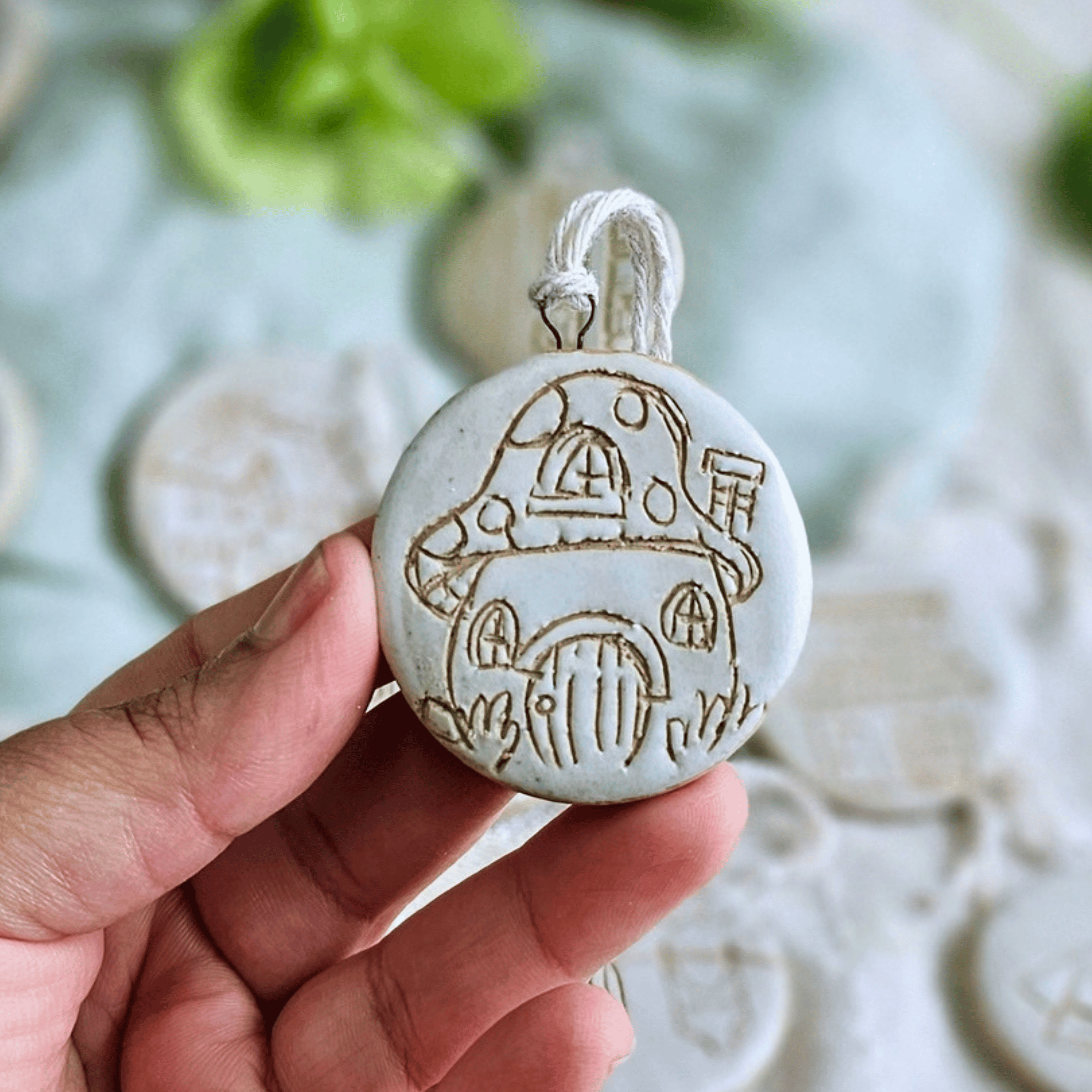 Ornaments_sgraffito_white glaze_in hand_mushroom houses.png