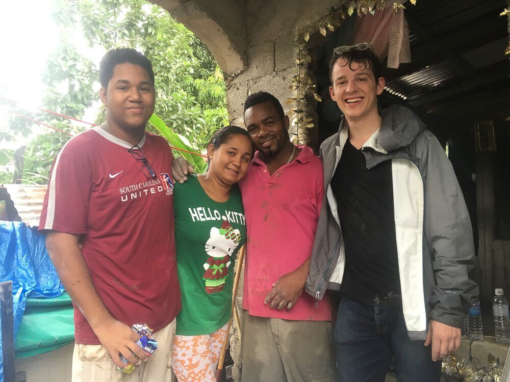 Thanksgiving morning, a group of travelers on Fathom Cruises help pour a cement floor for a Dominican Family.