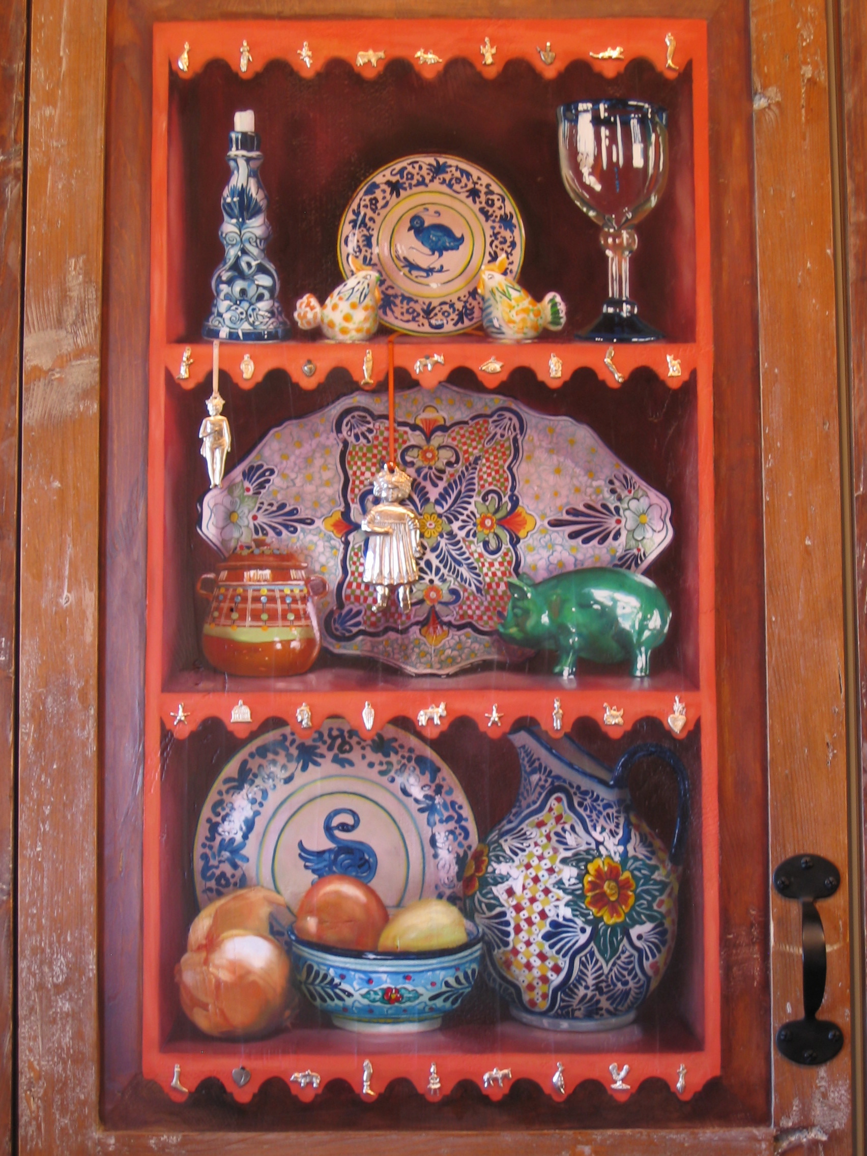 Trompe l'oeil shelves and objects painted on wooden cupboard