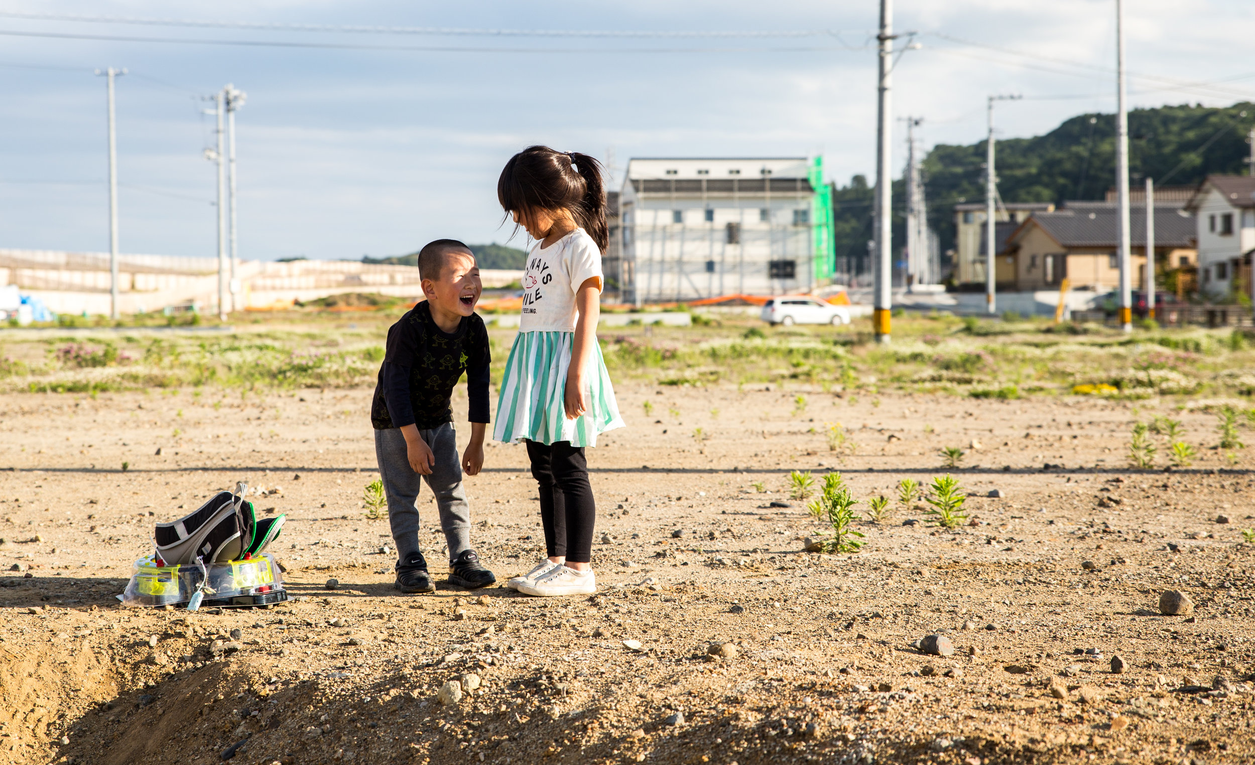  Children play in a dirt lot on the coastal town of Hisanohama. The city is still working to rebuild the homes and businesses that were destroyed by the tsunami.&nbsp; 