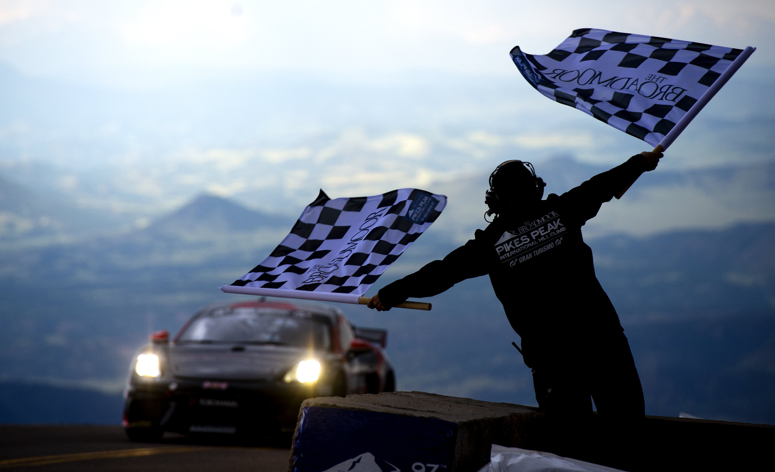  Derek Jordan waves the checkered flags from the finish line during the Broadmoor Pikes Peak International Hill Climb at the summit of Pikes Peak on Sunday, June 30, 2019. 