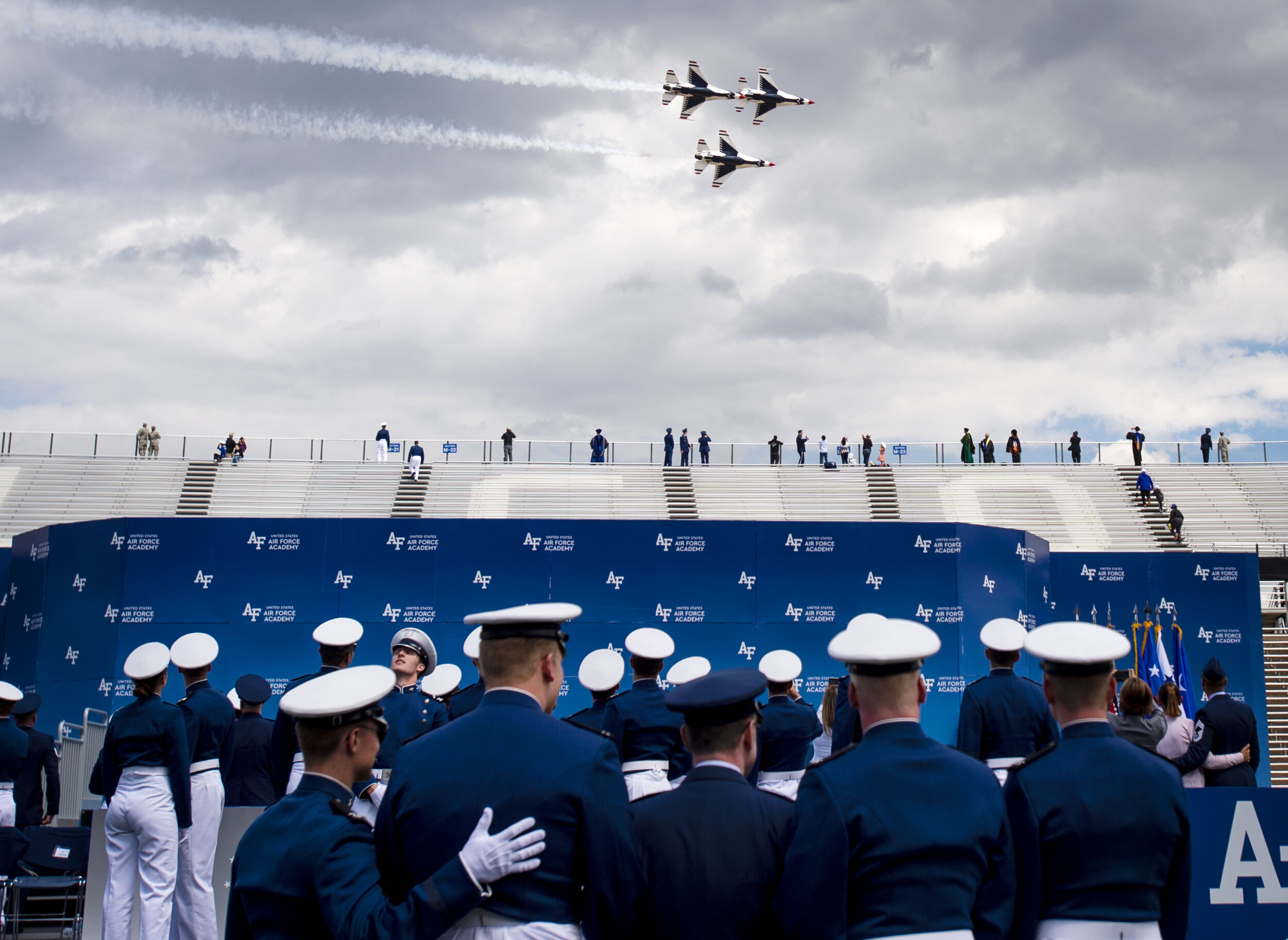  Cadets watch the Thunderbirds perform an air show after the Air Force Academy graduation at Falcon Stadium in Colorado Springs, Colo., on Thursday, May 30, 2019. 