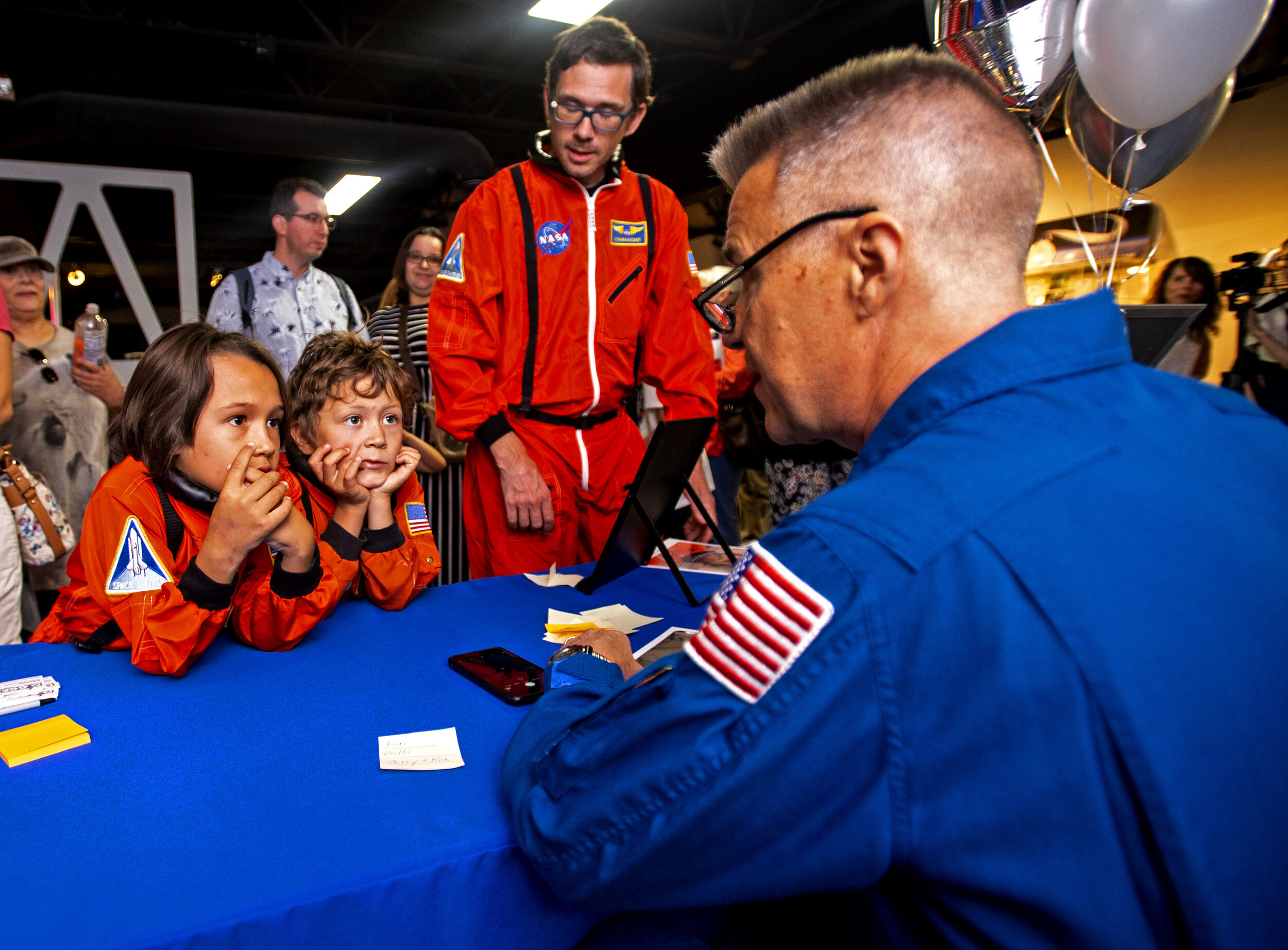  From left, Bodhi and Kai Cabeen lean in while talking with astronaut Duane Carey at the Space Foundation Discovery Center's celebration of the 50th anniversary of Neil Armstrong and Buzz Aldrin's walk on the moon Saturday, July 20, 2019, in Colorado