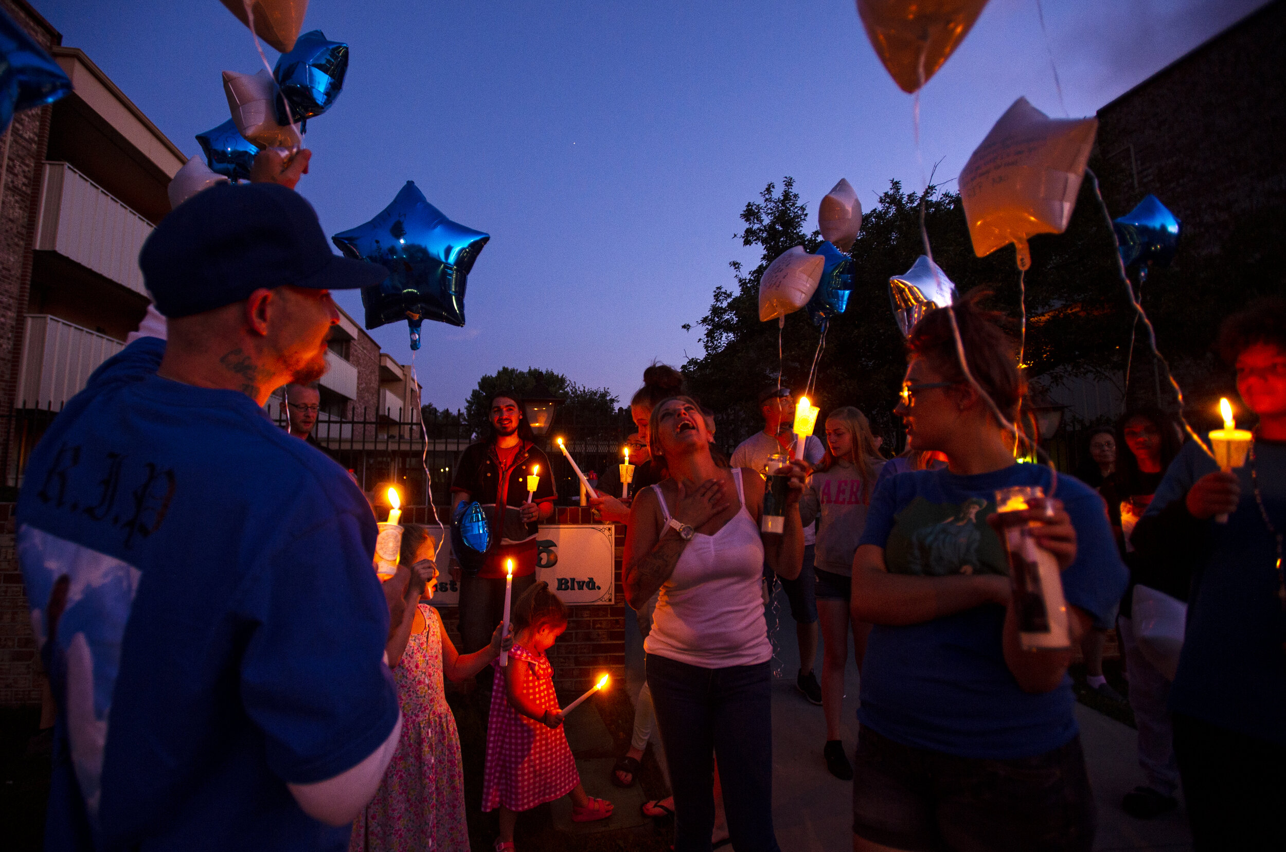  Friends and family of Joshua Vigil gather at the Fountain Garden Apartment complex in Colorado Springs, Colo., and join in song before releasing blue and white balloons in remembrance of him. Vigil was shot by Colorado Springs police officers at the