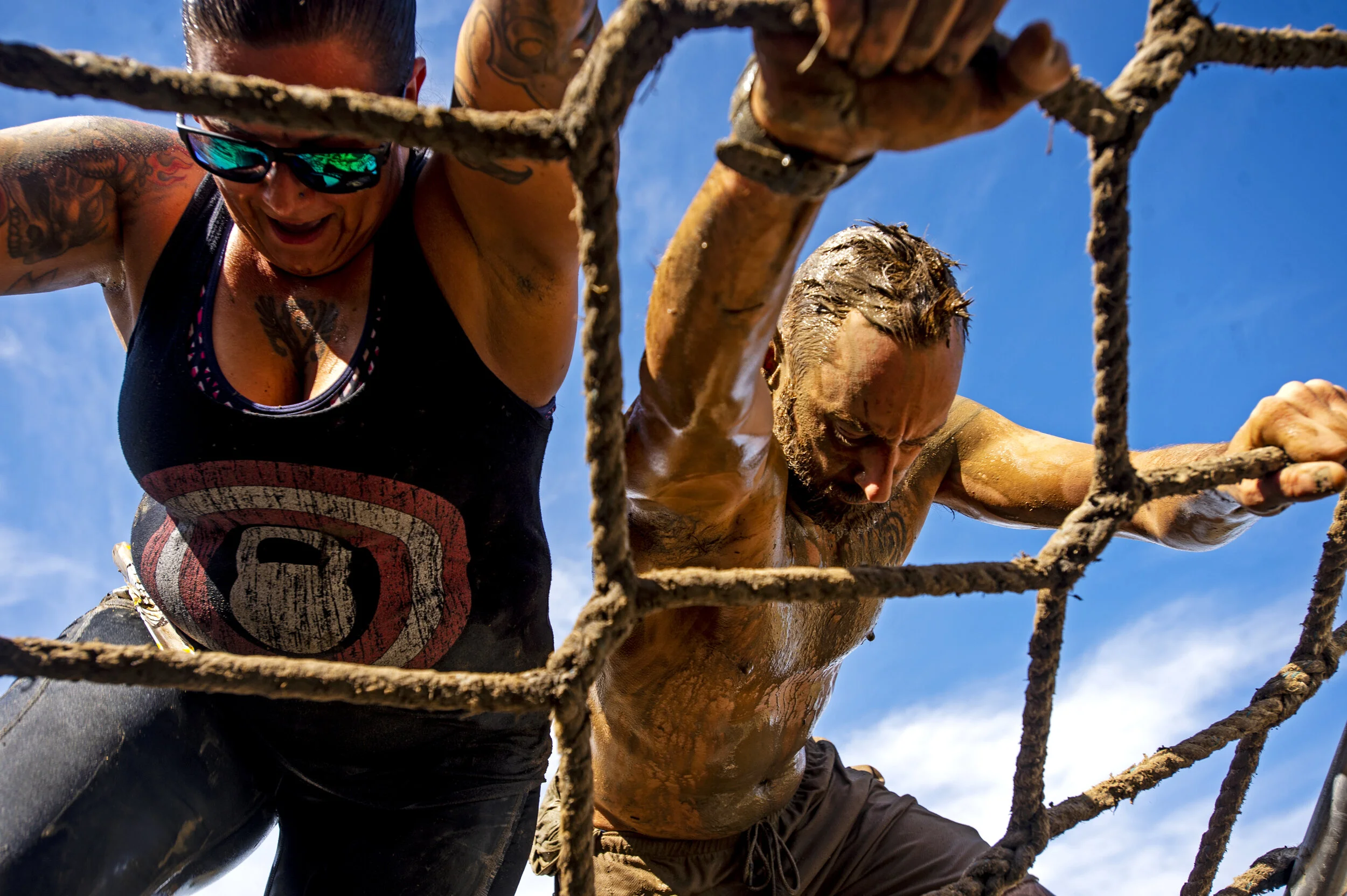  Runners make their way down a rope obstacle during the Muddy Dash at RAM Off-Road Park in Colorado Springs, Colo., on Saturday, Sept. 14, 2019. 