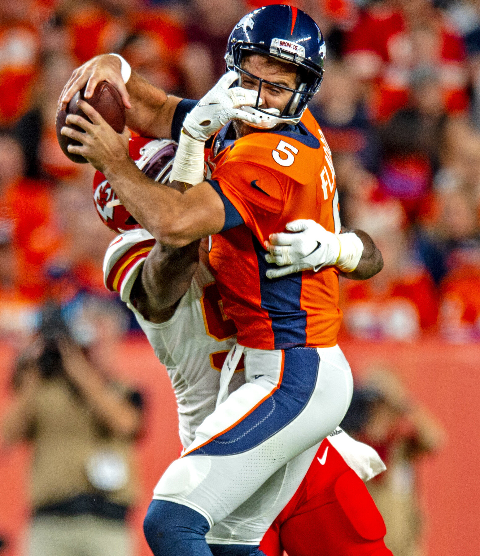  Denver Broncos quarterback Joe Flacco (5) gets sacked by Kansas City Chiefs defensive end Alex Okafor (97) for a three yard loss during the first quarter of the Broncos game against the Kansas City Chiefs at Empower Field at Mile High in Denver, Col