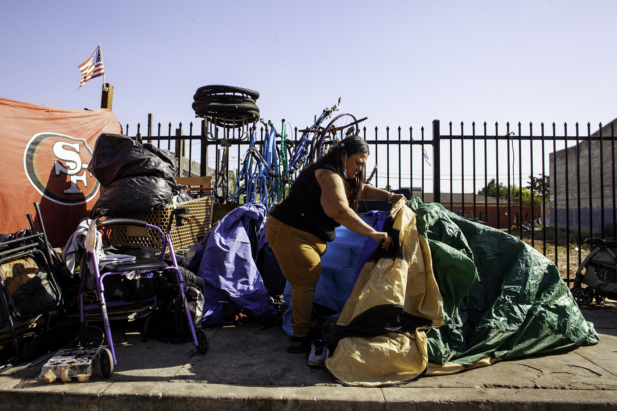  Aurilia Guzmán arranges her “little tent,” as she calls it, in Chinatown in Salinas, Calif. on Oct. 26, 2020. She and others had to leave before a city cleanup to address sanitation issues. 