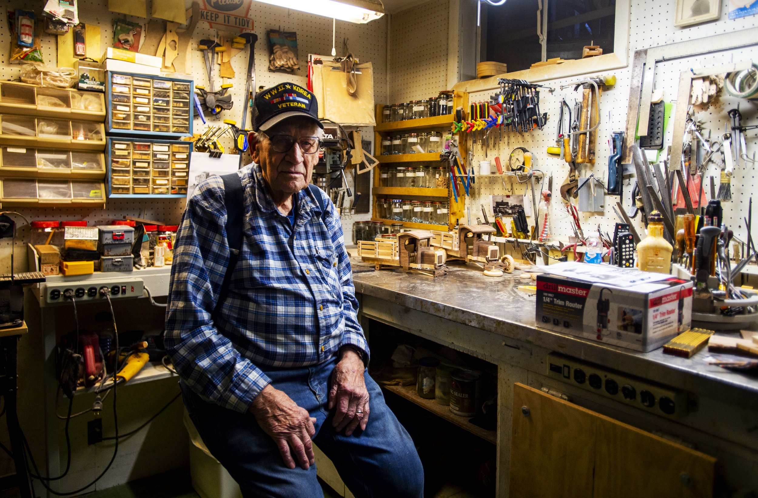  World War II veteran and woodworker Bill Vanaman poses for a portrait in his shop in the basement of his Colorado Springs home on December 3, 2019.  