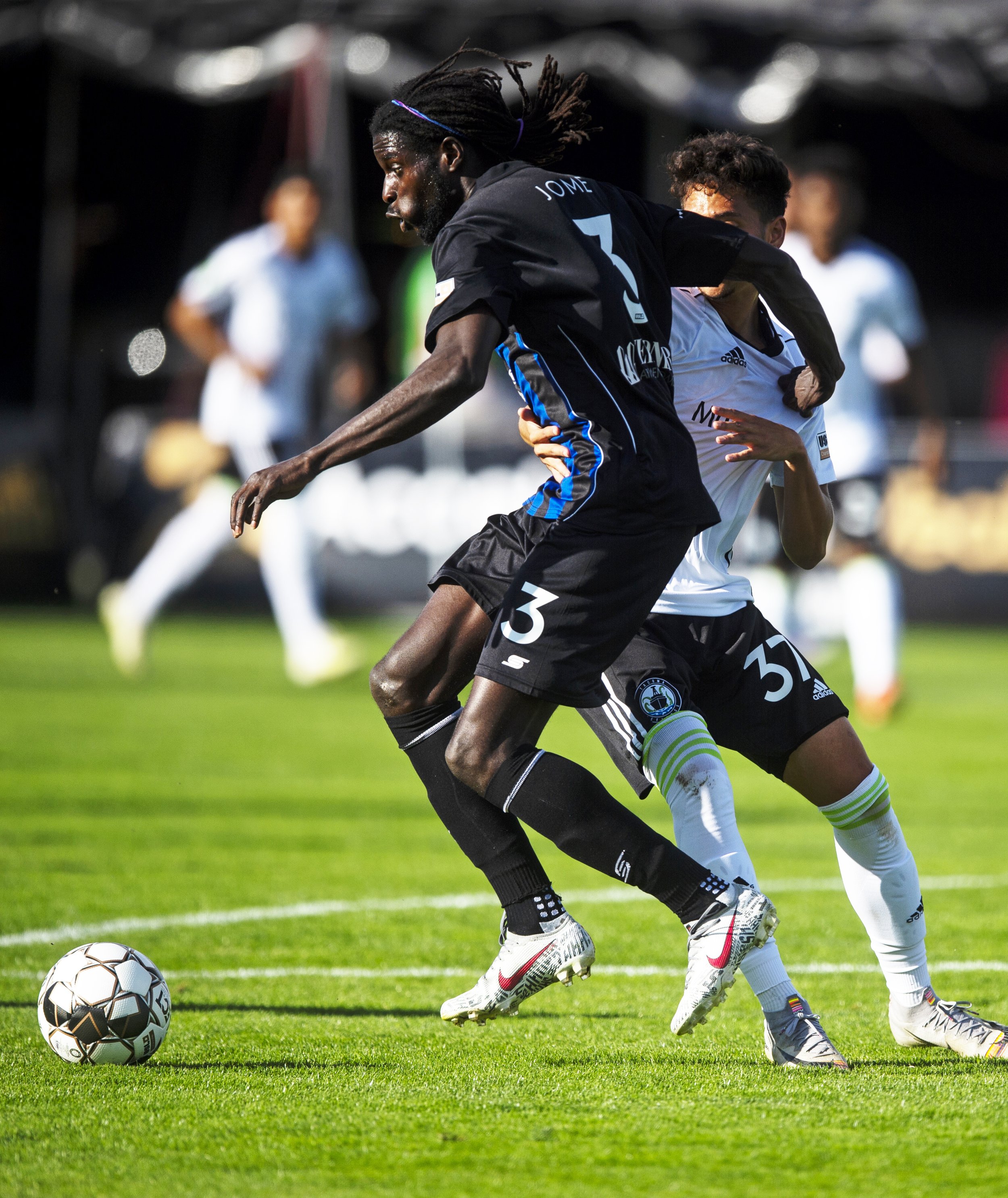  Colorado Switchbacks defensive forward Ismaila Jome (3) wrestles past Tacoma Defiance forward Shandon Hopeau (37) during a home game on Saturday, June 8, 2019. 
