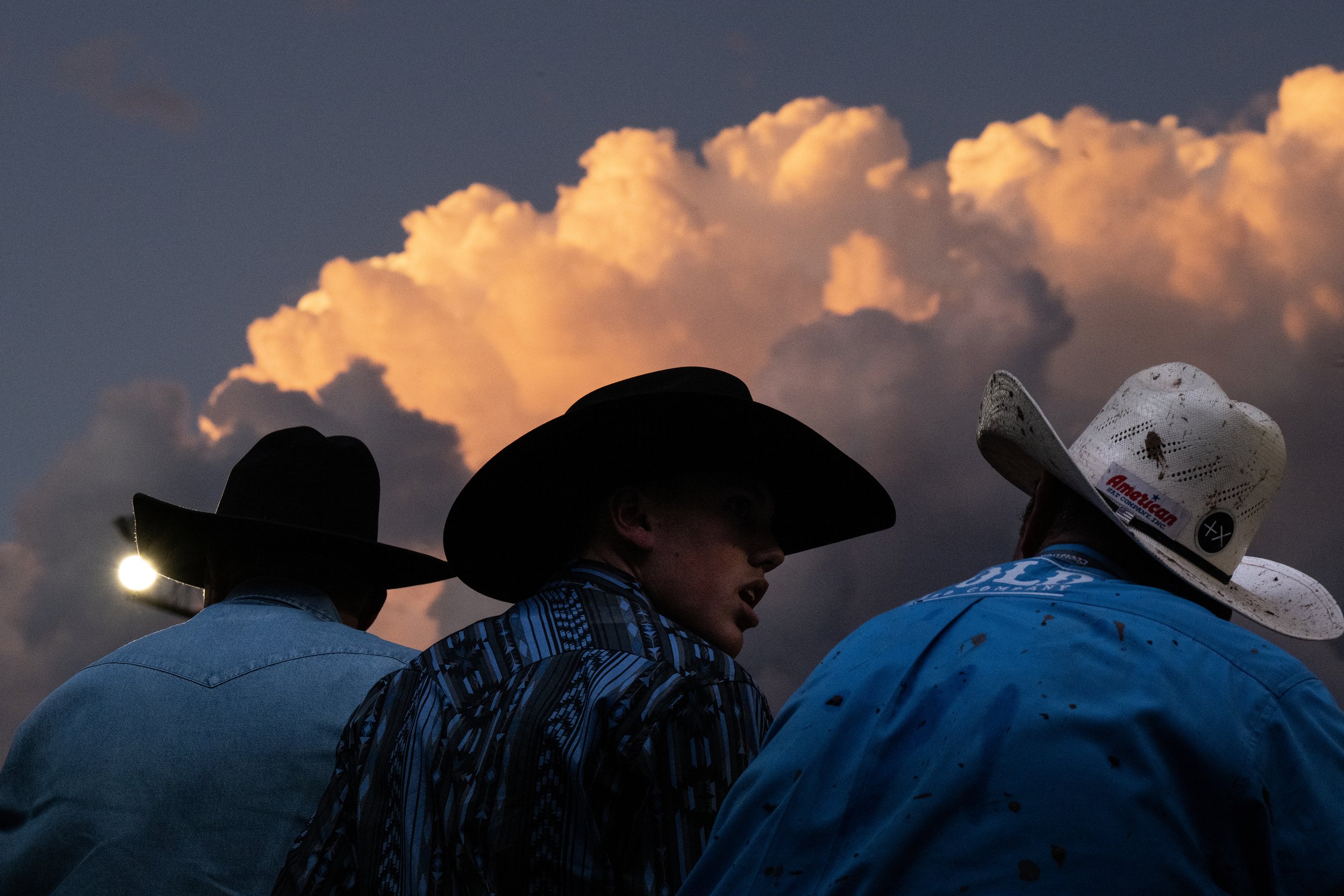  A group of cowboys watch the Pikes Peak or Bust Rodeo from the chutes on Saturday, July 15, 2023, at the Norris Penrose Event Center in Colorado Springs, Colo. 