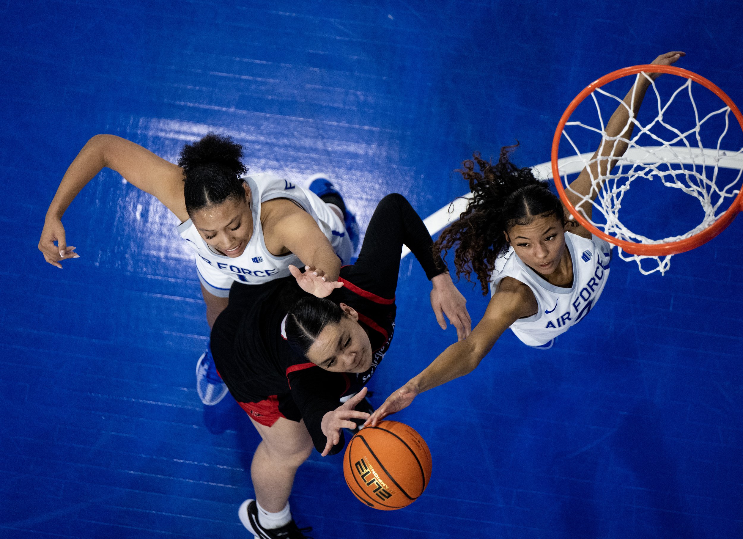  Air Force guards Alexis Cortez (1) and Milahnie Perry (2) and San Diego State forward Khylee Pepe (0) reach for a rebound in the first half of a NCAA basketball game on Wednesday, Jan. 3, 2024, at Clune Arena at Air Force Academy, Colo.  