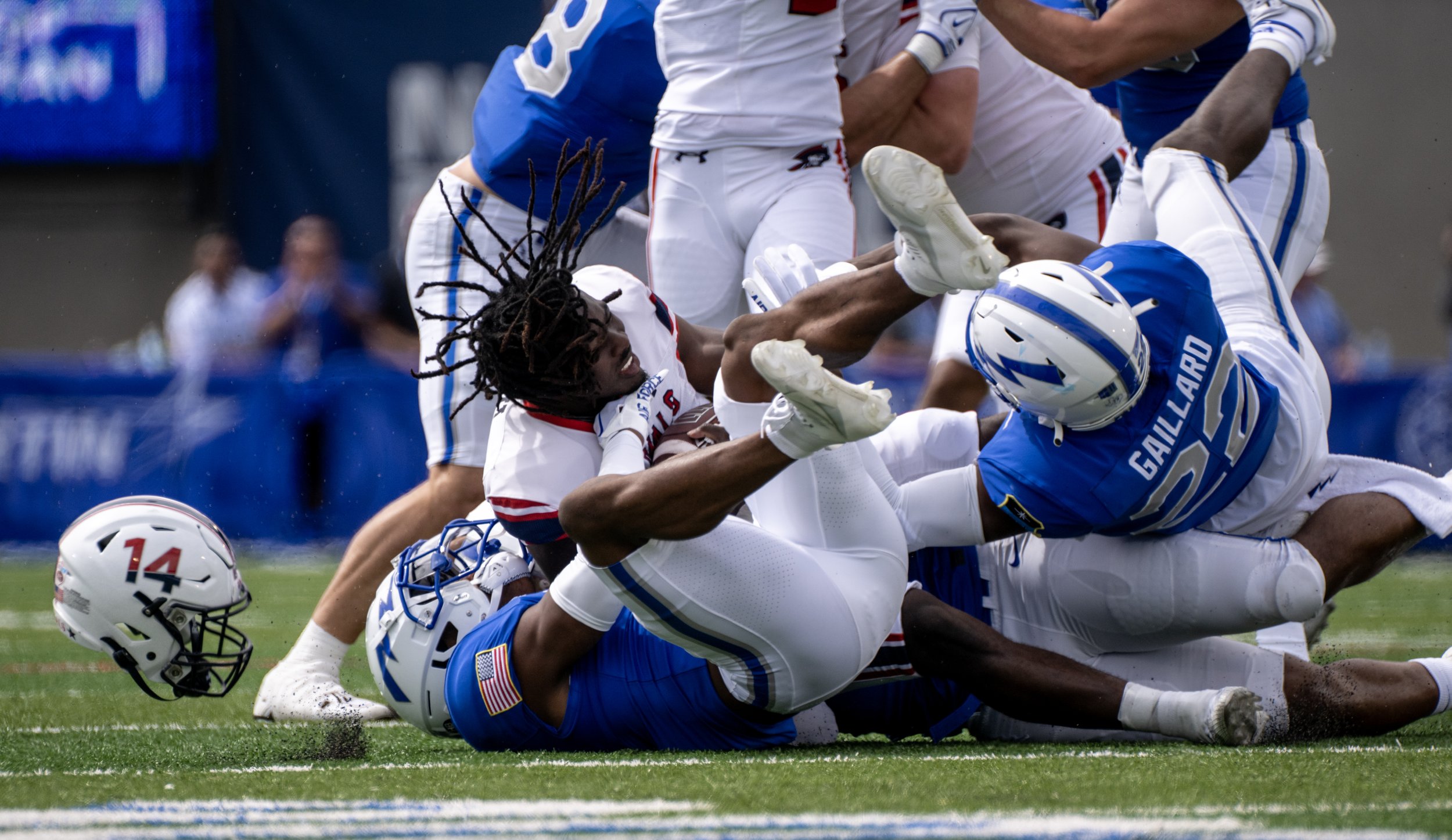  Robert Morris Colonials wide receiver Noah Robinson’s (14) helmet flies off as he is tackled by a horde of Air Force Falcons during the first half of a NCAA football game on Saturday, Sept. 2, 2023, at Air Force Academy, Colo. 