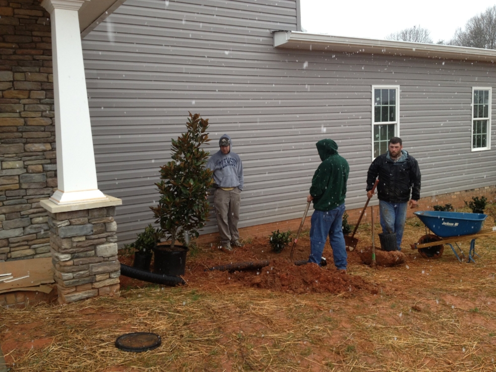 Many volunteers were used in building Sandra's Home. Here is Putnam Baptist Church men's group planting trees and shrubs.