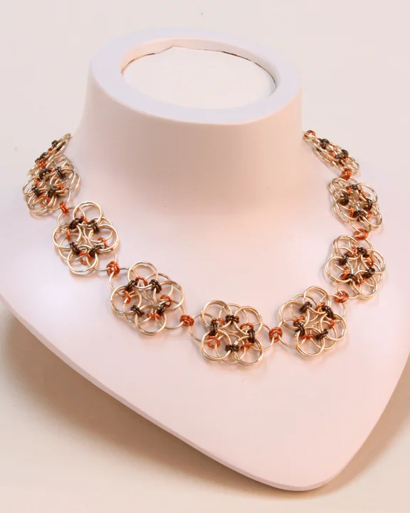  This necklace is made of silver-, black- and copper-colored jump rings in a Celtic floral pattern. It is one-of-a-kind piece with a toggle closure.  Available at:  https://www.etsy.com/listing/92413295/laura-collection-necklace?ref=shop_home_active_