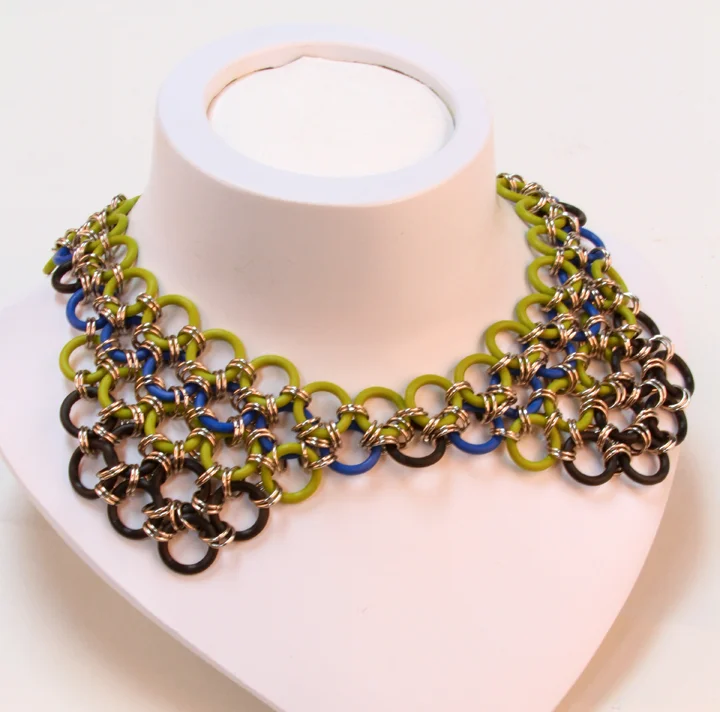  This beautiful, funky necklace makes a big statement in Asian-inspired chainmaille. Black, lime green &amp; royal blue silicone chainmaille linked with silver-colored rings. 16" long  Available at:  https://www.etsy.com/listing/235143489/shiobann-co