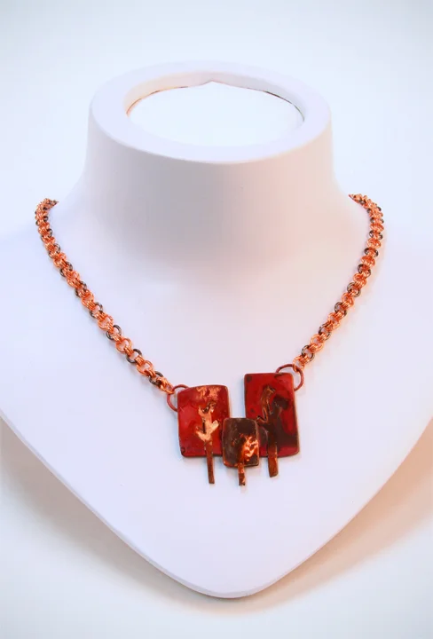  This one-of-a-kind piece consists of a forest of copper and yellow brass trees with a heat patina on a copper-, and black-colored copper chain with a toggle closure.  Available at:  https://www.etsy.com/listing/92416853/maggie-collection-necklace?re
