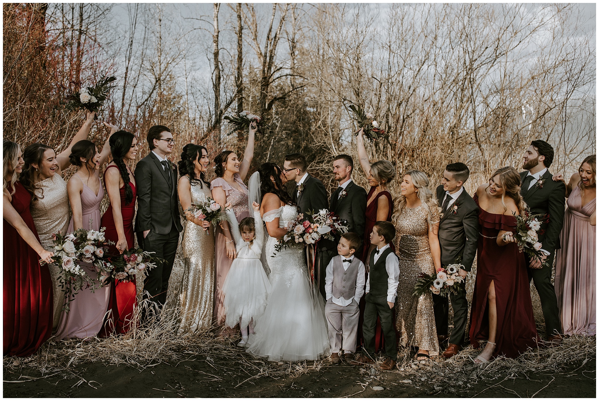 A big bridal party photo outside of the Fraser River Lodge 