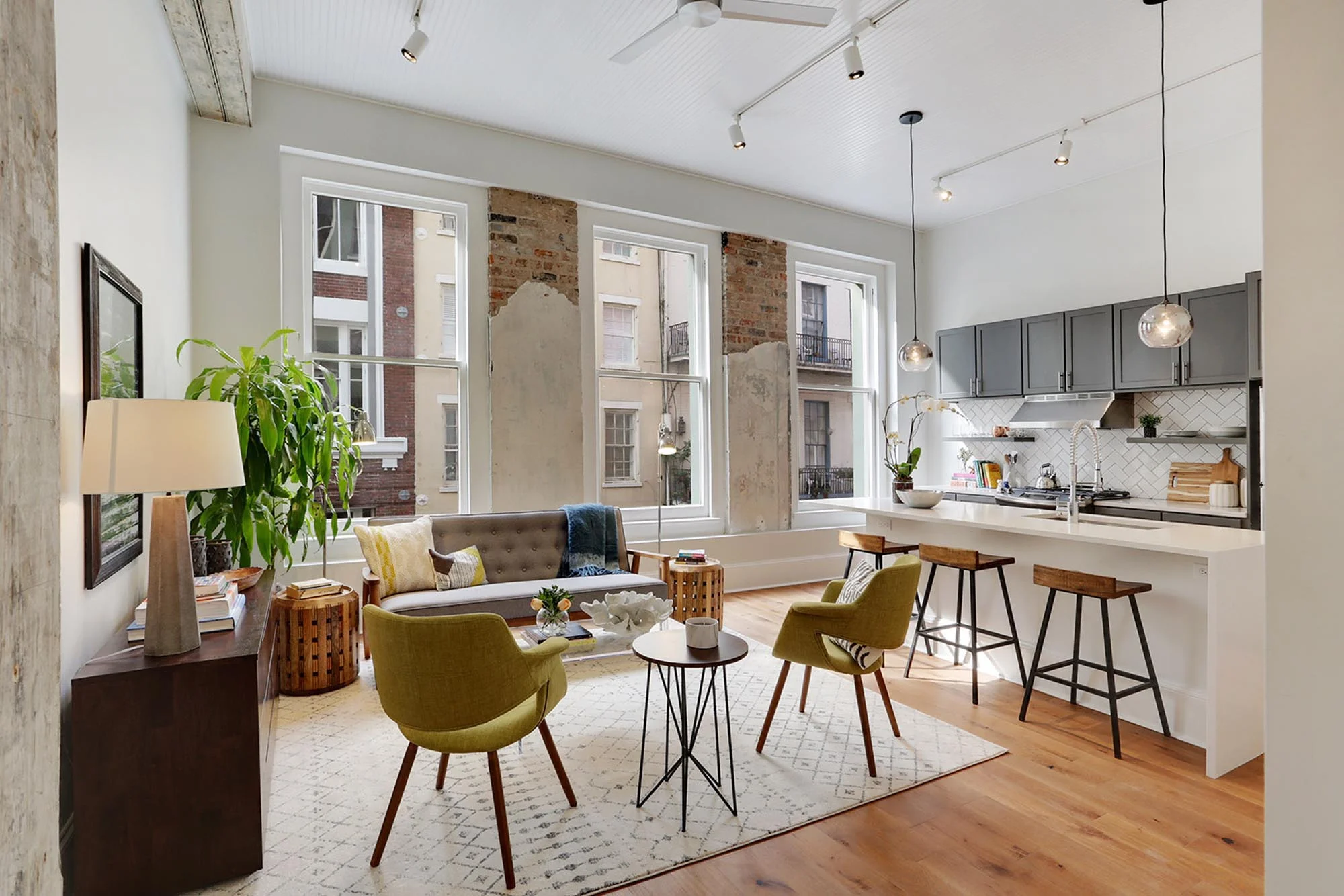 Brightly lit modern kitchen and mid century modern style sitting area