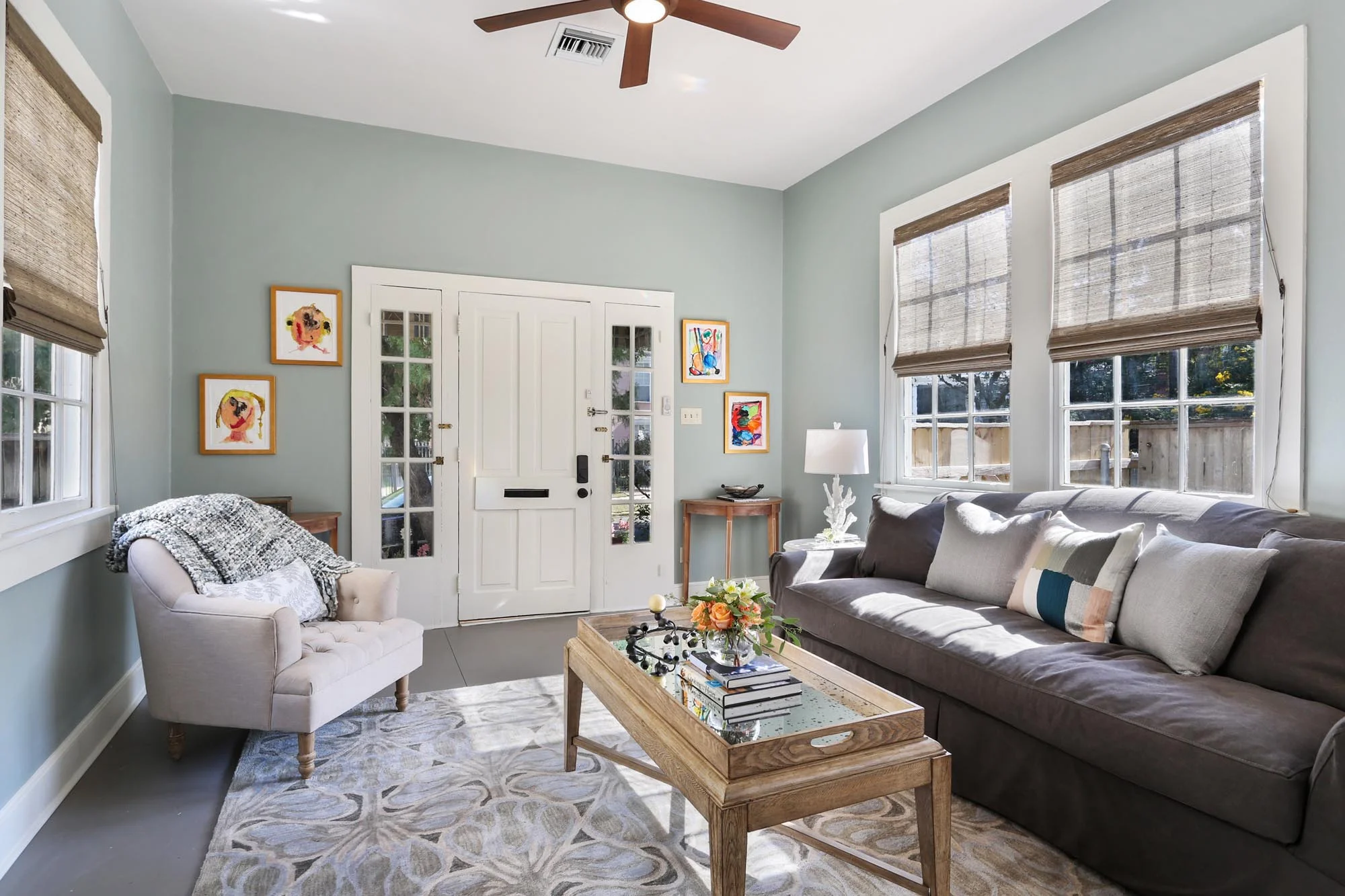 Comfortable seating area with colorful small paintings on the wall